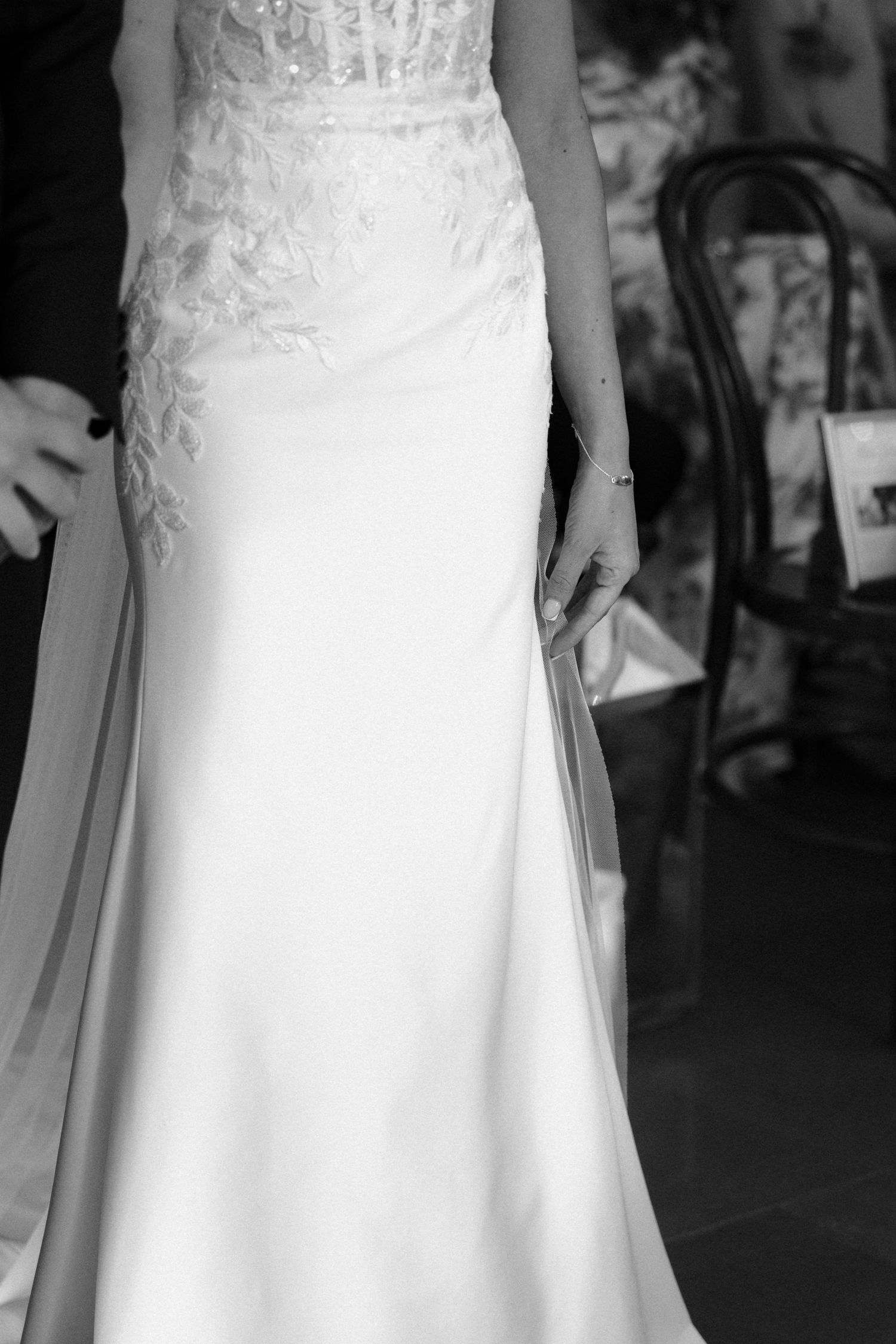 Elegant white wedding dress with delicate lace details and flowing skirt shown in multiple detail shots.