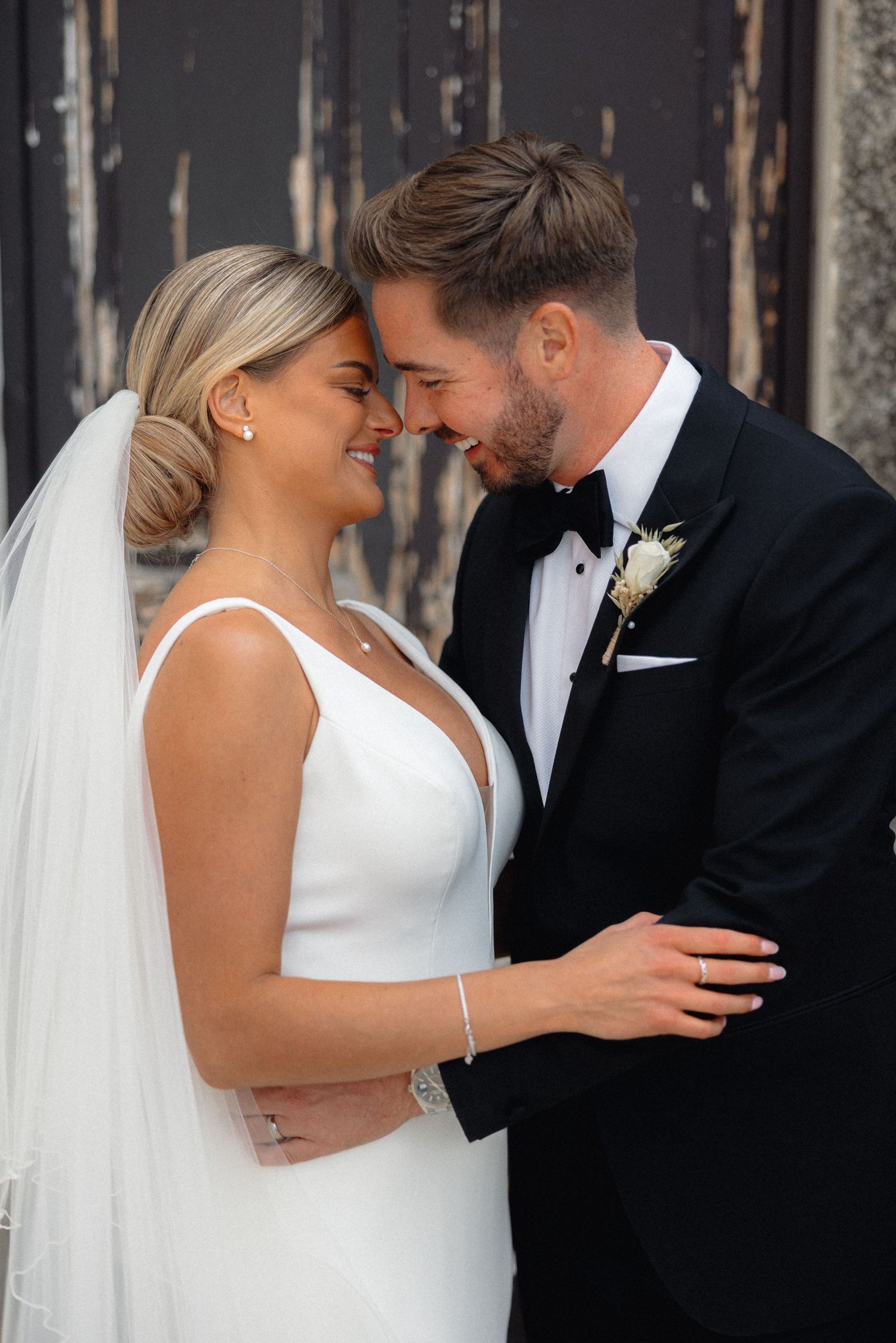 Intimate black and white wedding portraits showing tender moments between newlyweds.