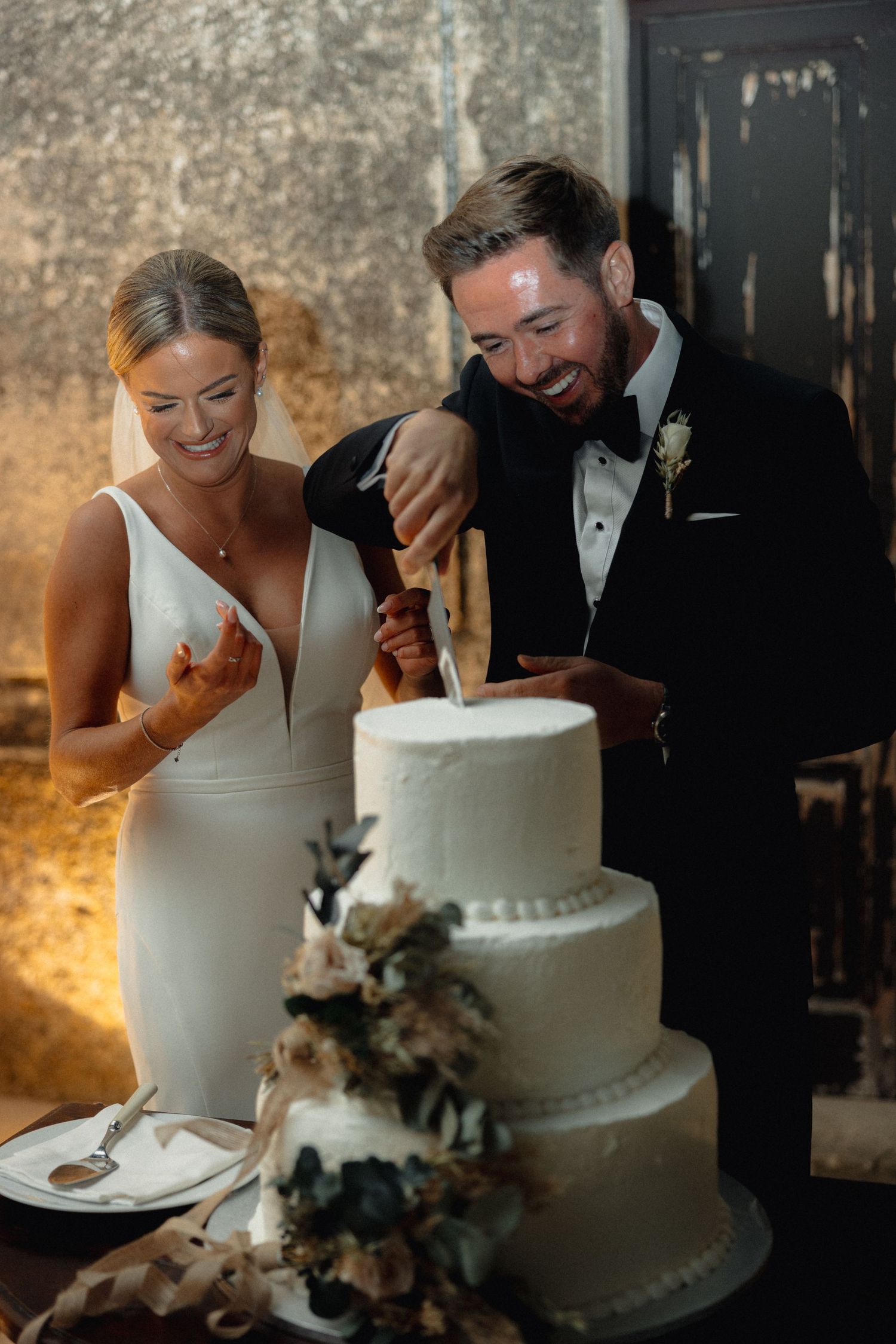 Close-up shots of bride and groom sharing wedding cake at their reception.