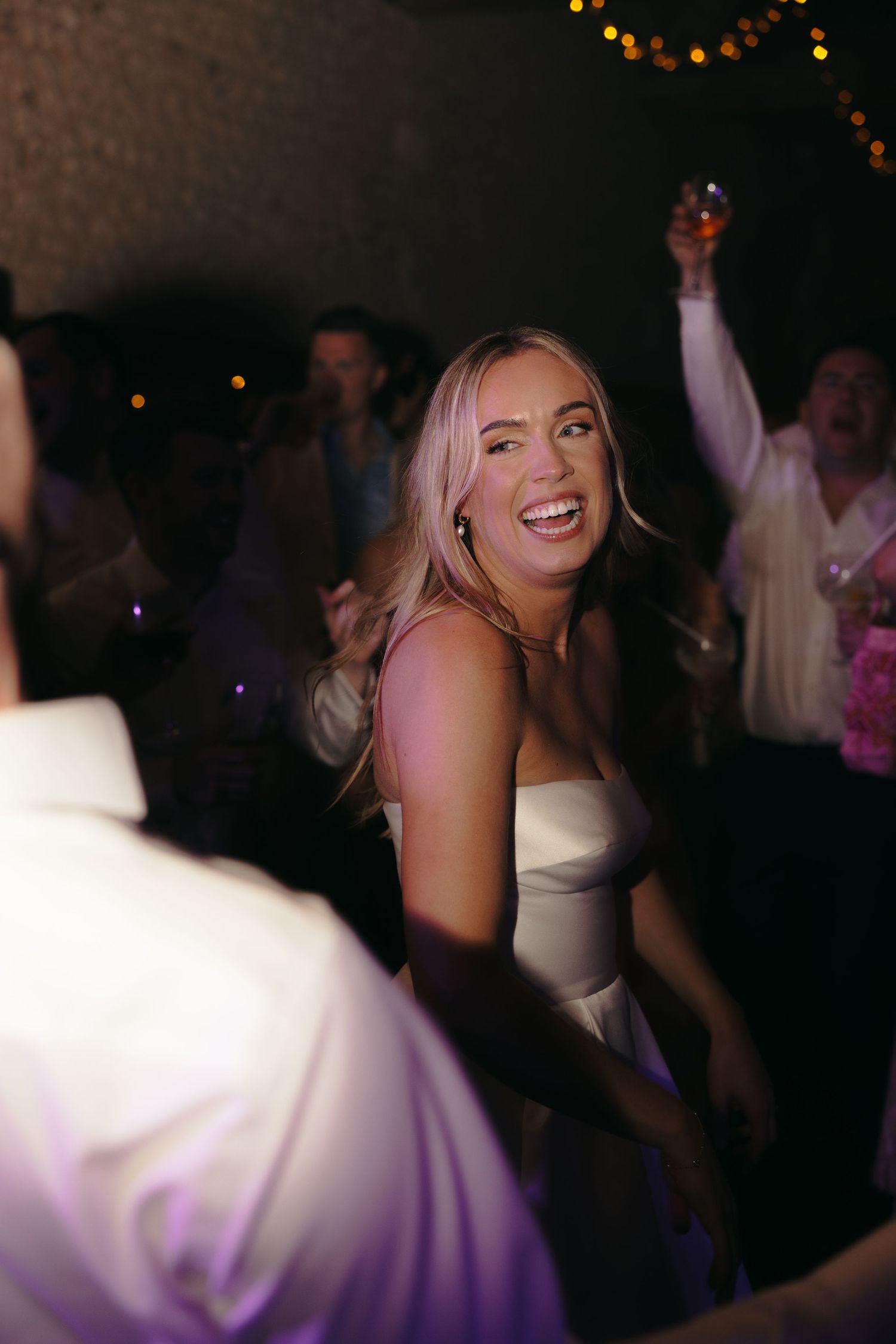 A joyful celebration on the dance floor with festive lighting and decorations.
