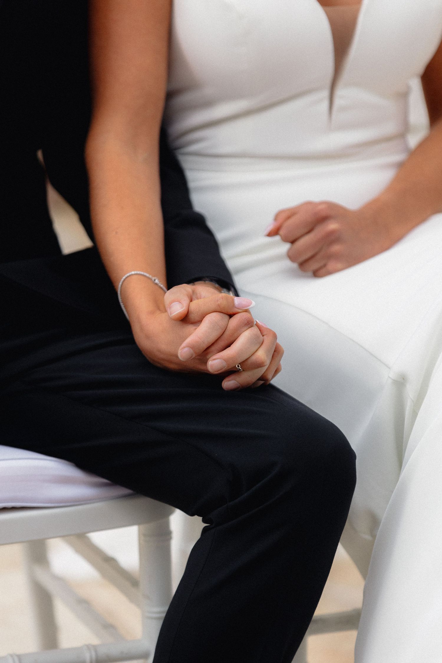 Close-up detail shot of formal wedding attire in black and white.