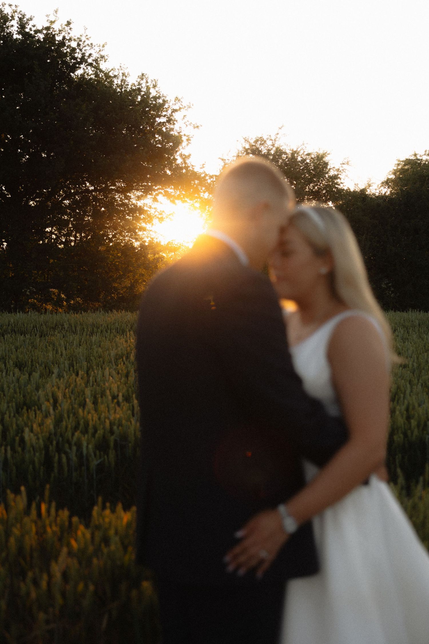 Romantic sunset portrait session in a wheat field.