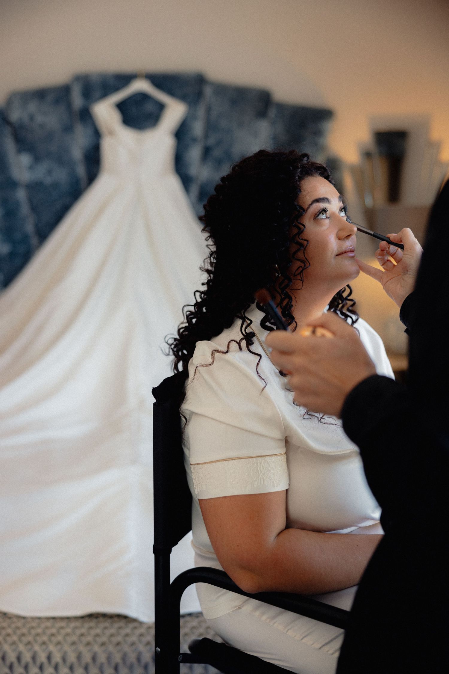 A series of intimate bridal portraits showing joyful expressions in white against a textured background.