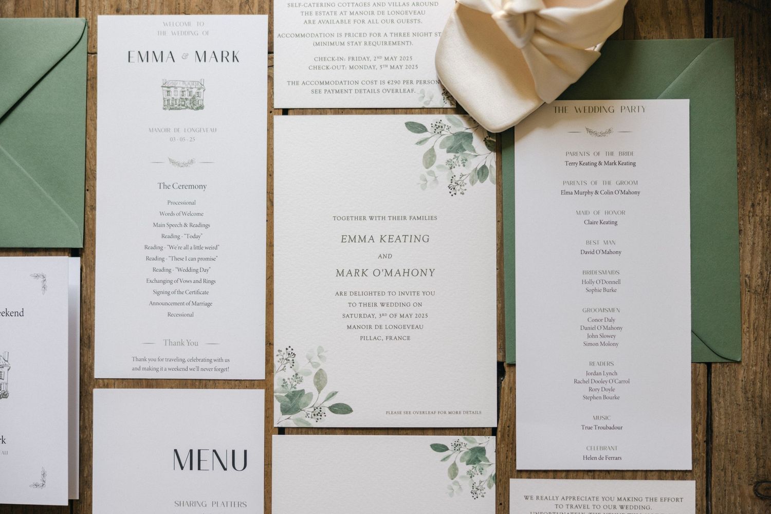 Elegant wedding stationery with floral details laid out on wooden surface.
