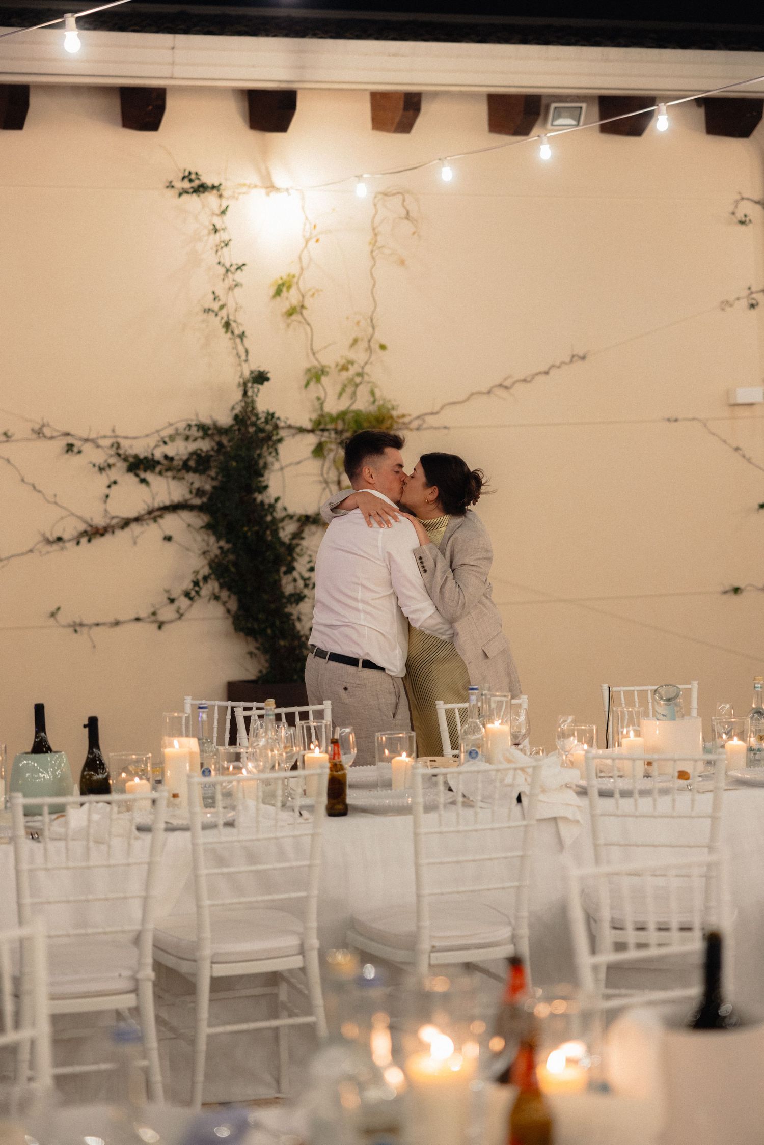 White reception room decorated with climbing vines and elegant table settings.