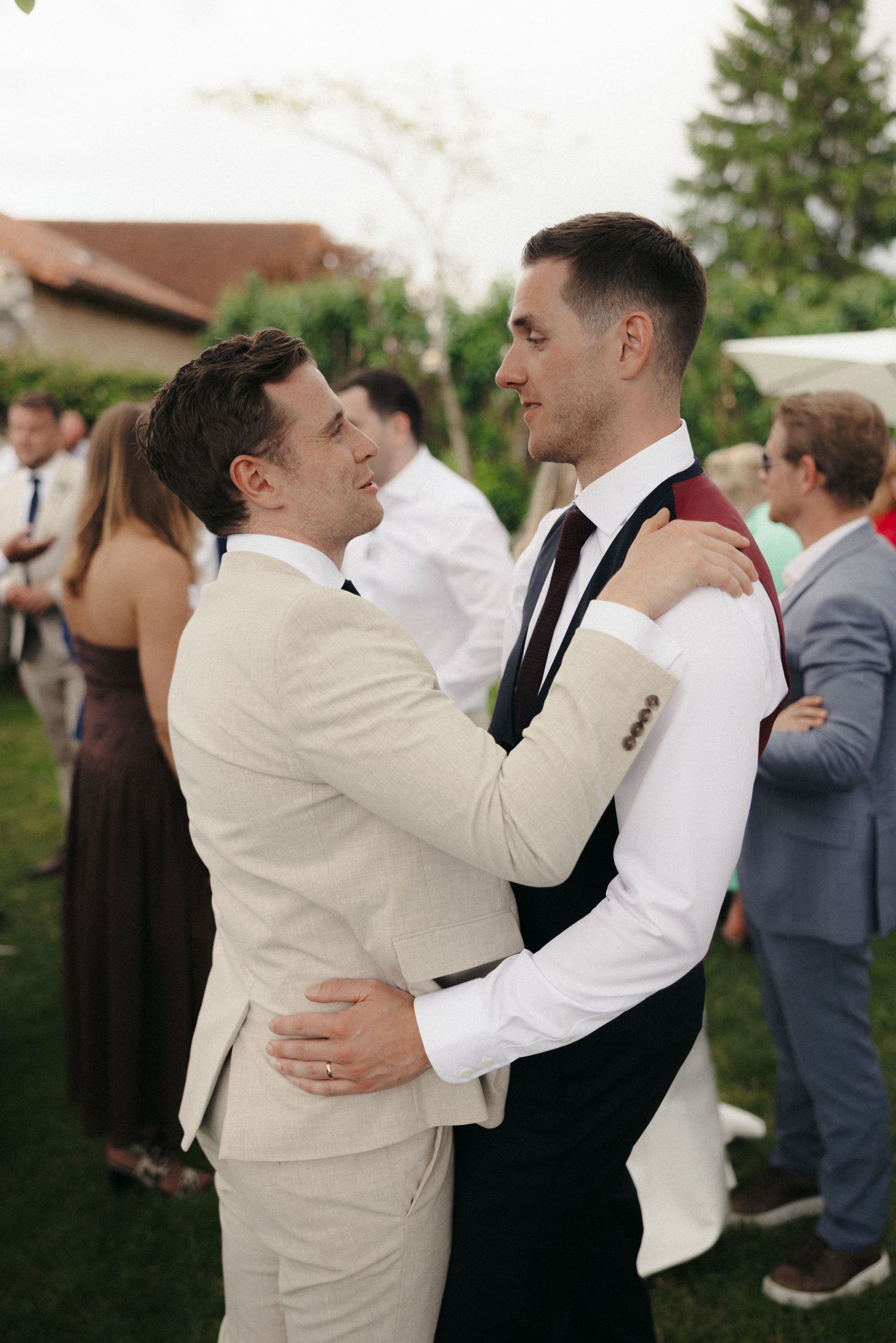Two people in formal attire embrace during a wedding celebration.