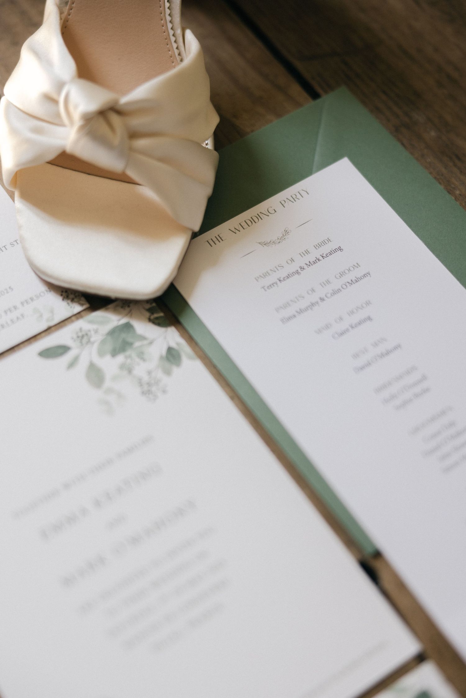 Wedding invitation suite with white paper and delicate floral designs.