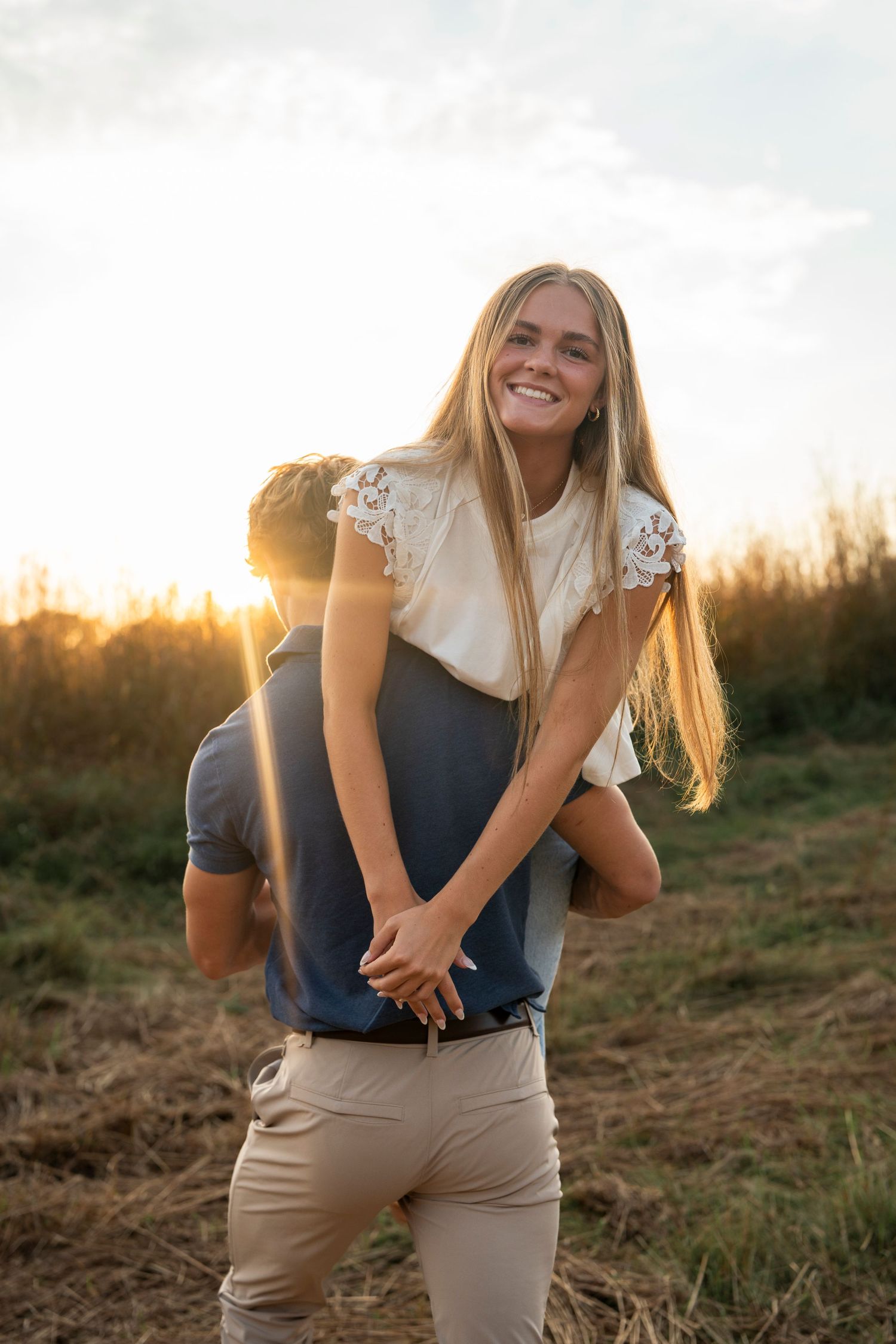 A joyful moment captured during golden hour in a rustic outdoor setting.