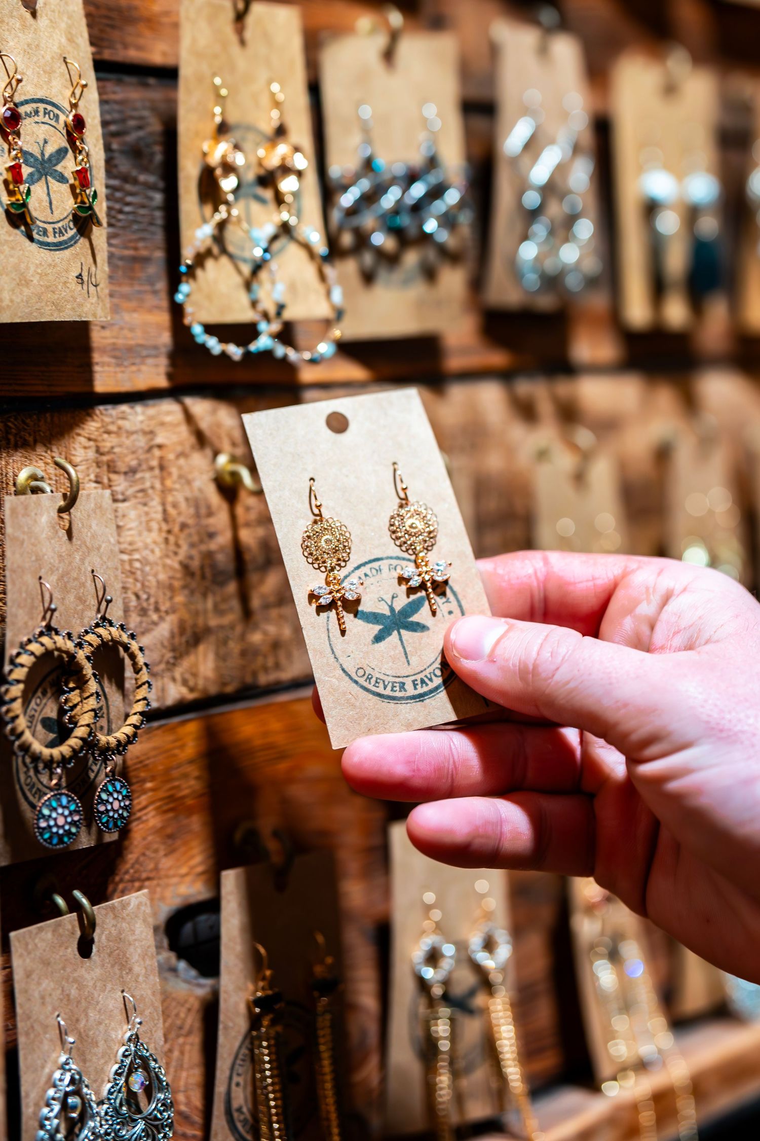Close-up of jewelry displays showing earrings and accessories on wooden display boards.
