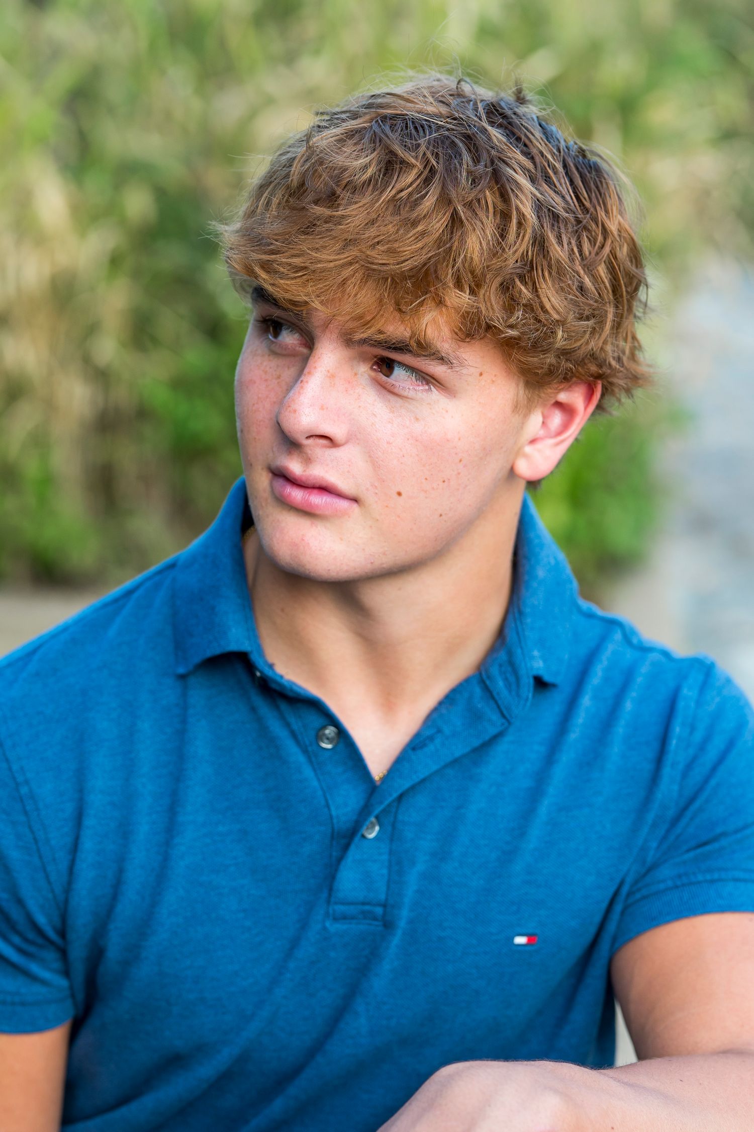 Close-up outdoor portrait wearing polo shirt with natural lighting.