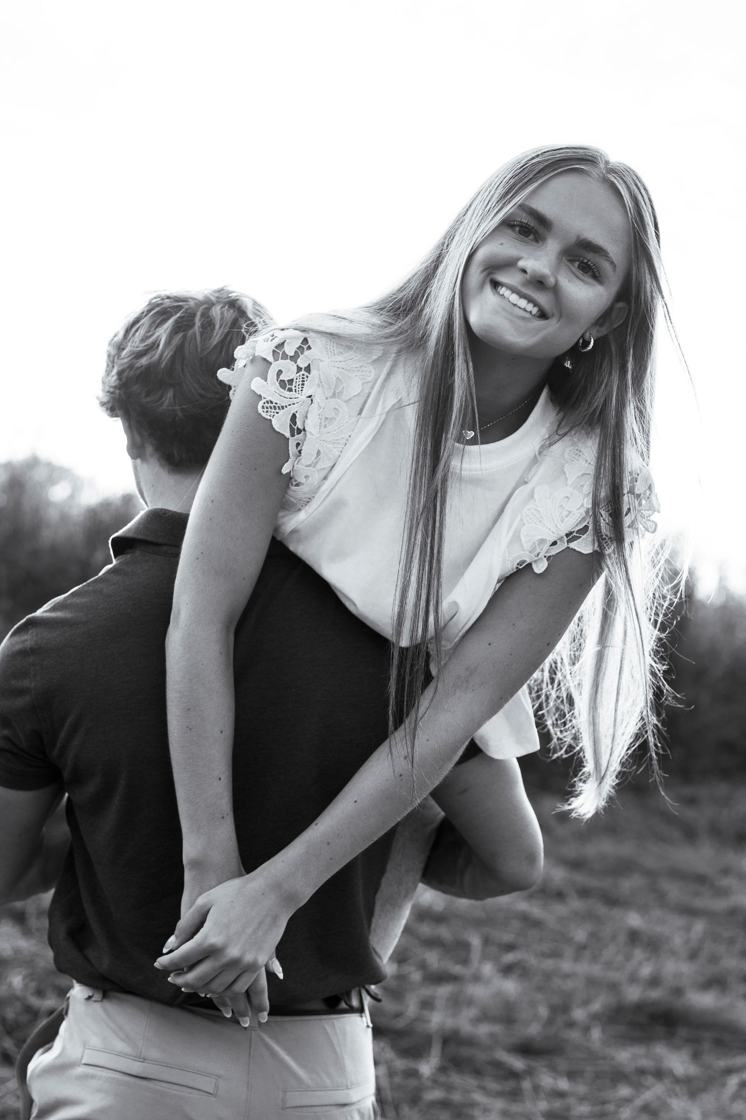 A black and white portrait of a romantic moment in nature.