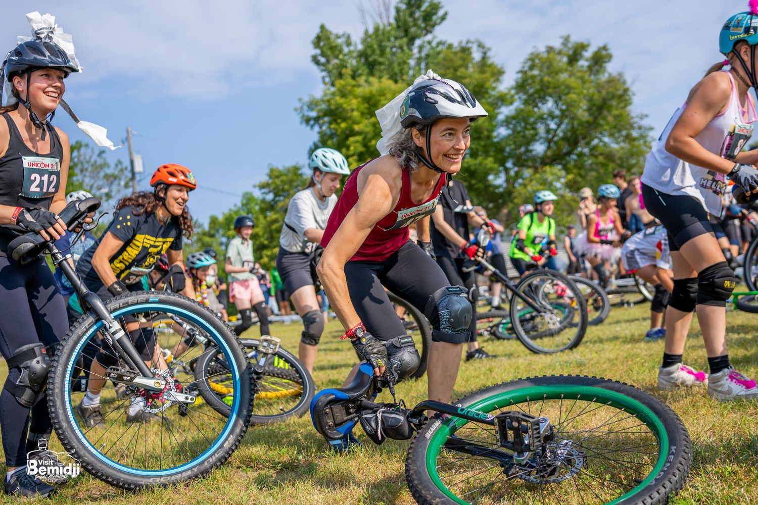 Group of cyclists engaging in a relay race.