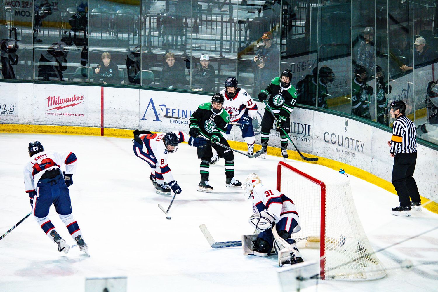 Hockey players in action during an intense match on the ice.