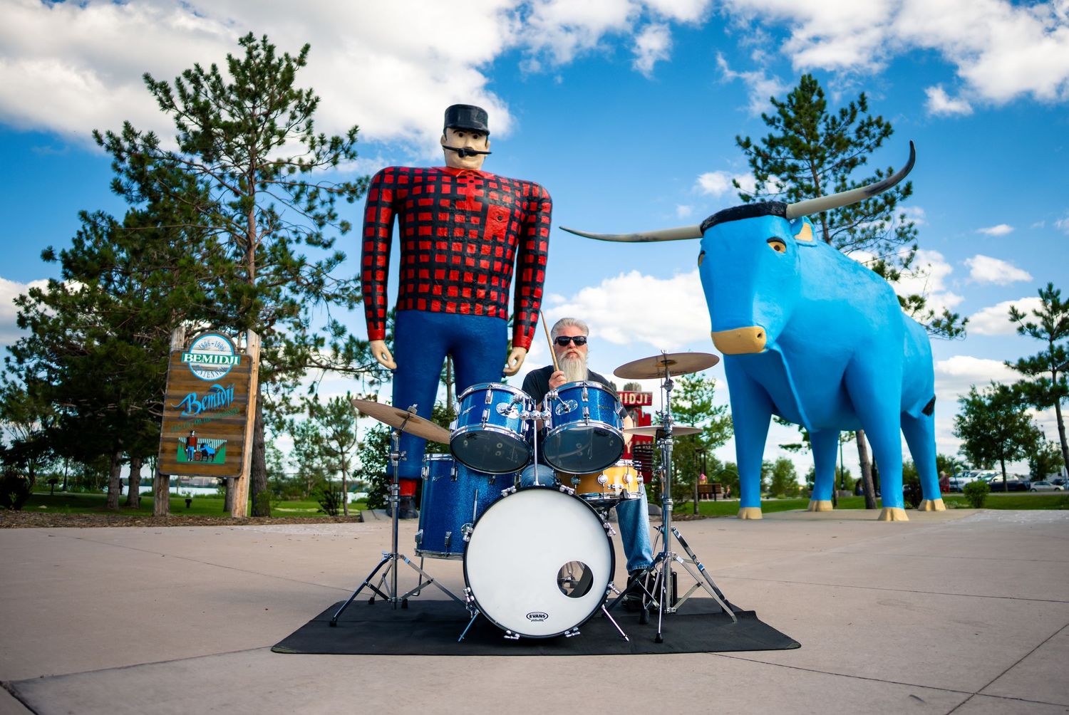 Drum set in front of Paul Bunyan and Babe the Blue Ox Statues in Bemidji.