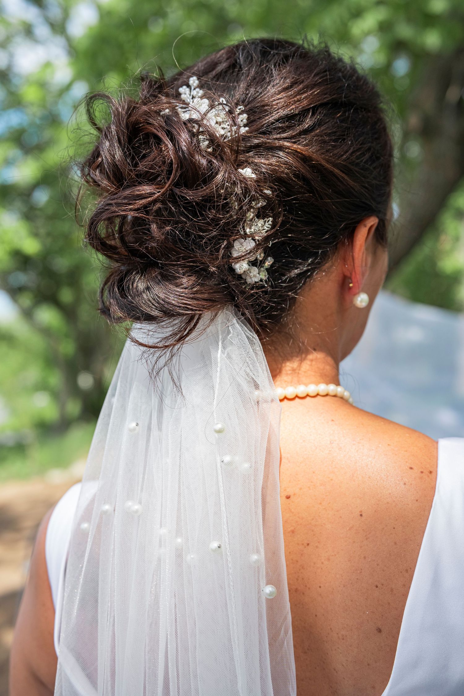 Close-up of bridal veil and hair accessories with delicate floral details.