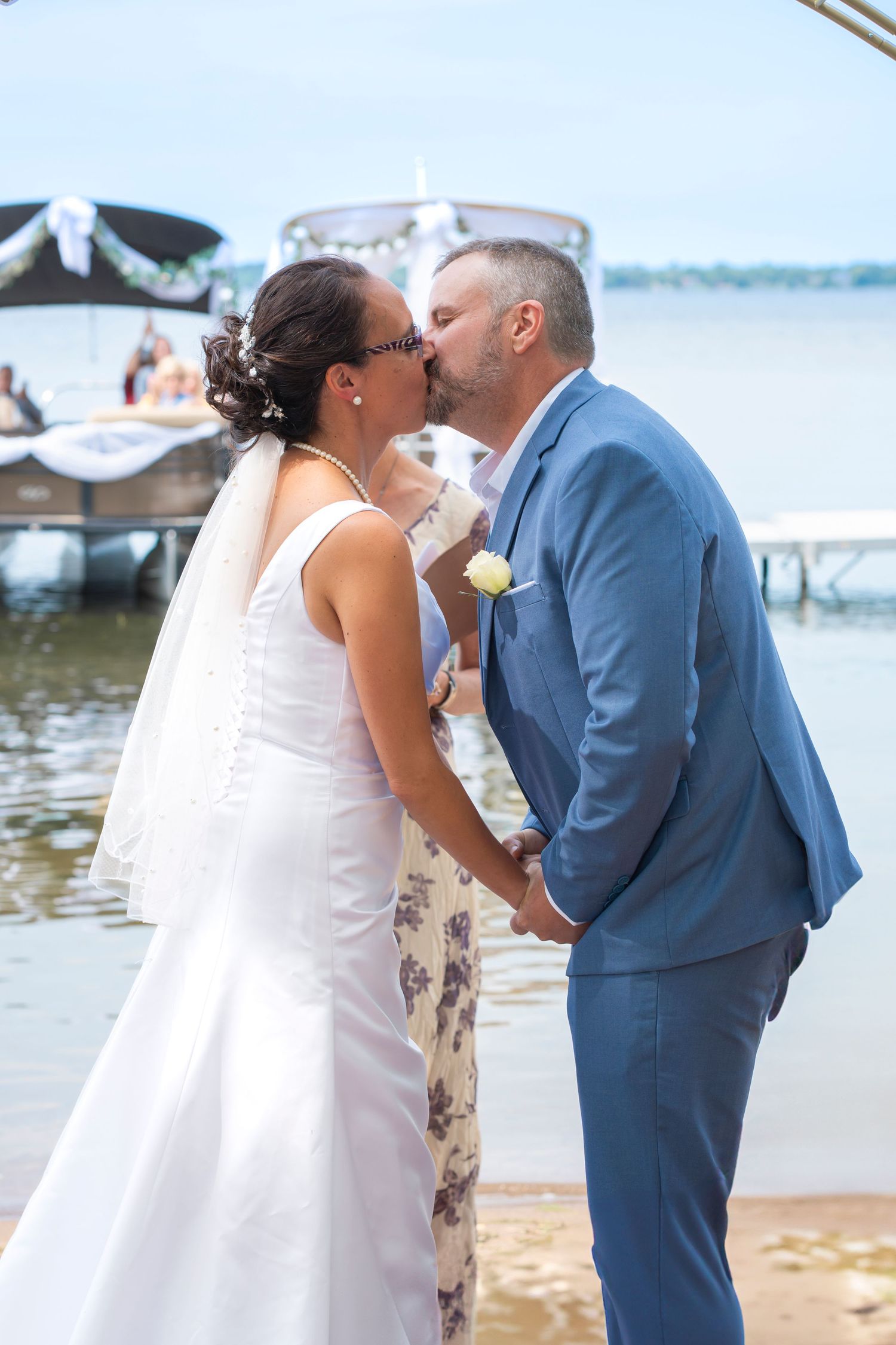Couple shares romantic moment during waterfront wedding ceremony.