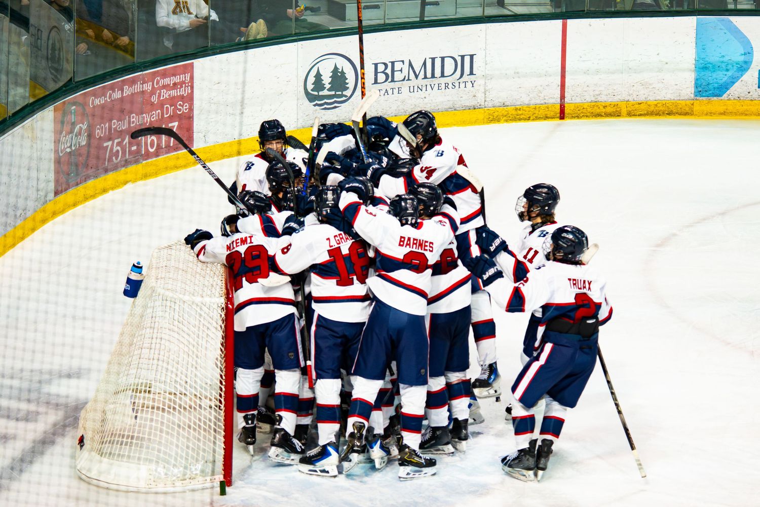 Ice hockey players competing in an intense game on the rink.