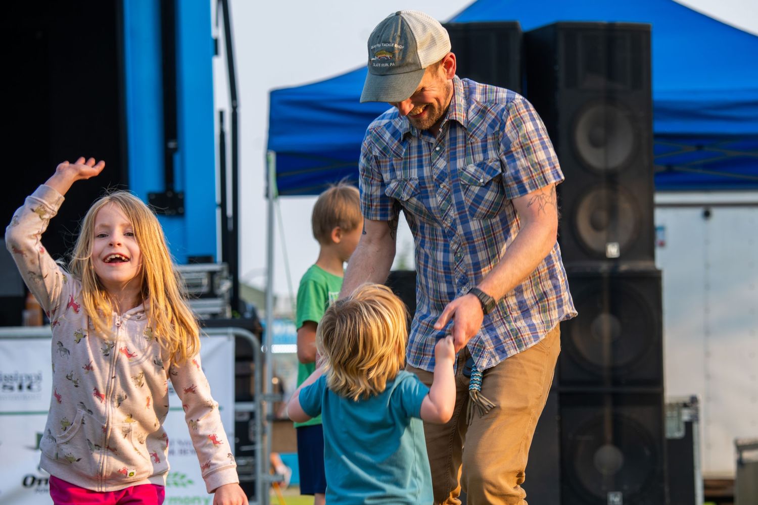 People dancing and celebrating at outdoor festival.