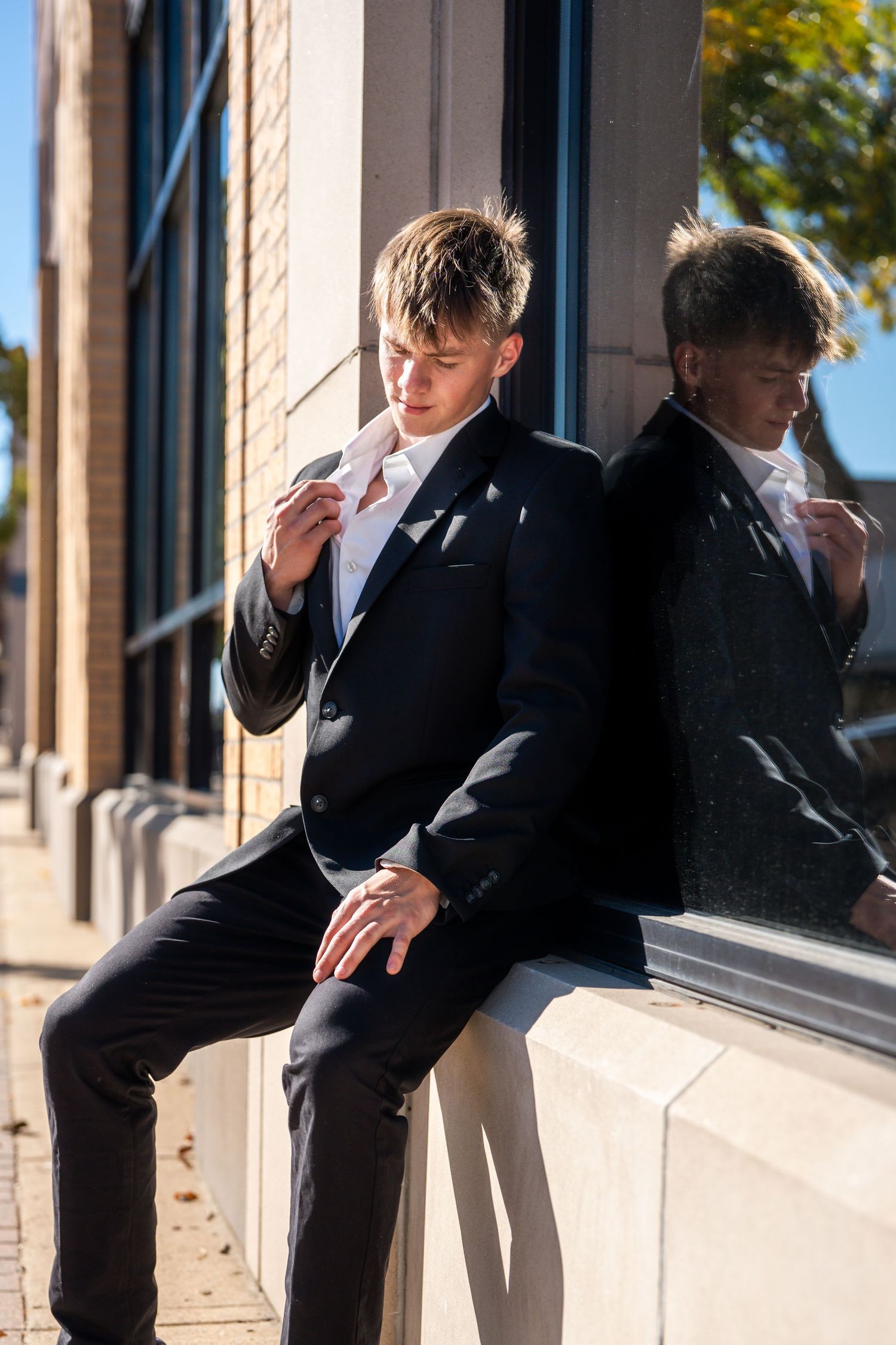 Creative fashion poses captured against building architecture in formal wear.