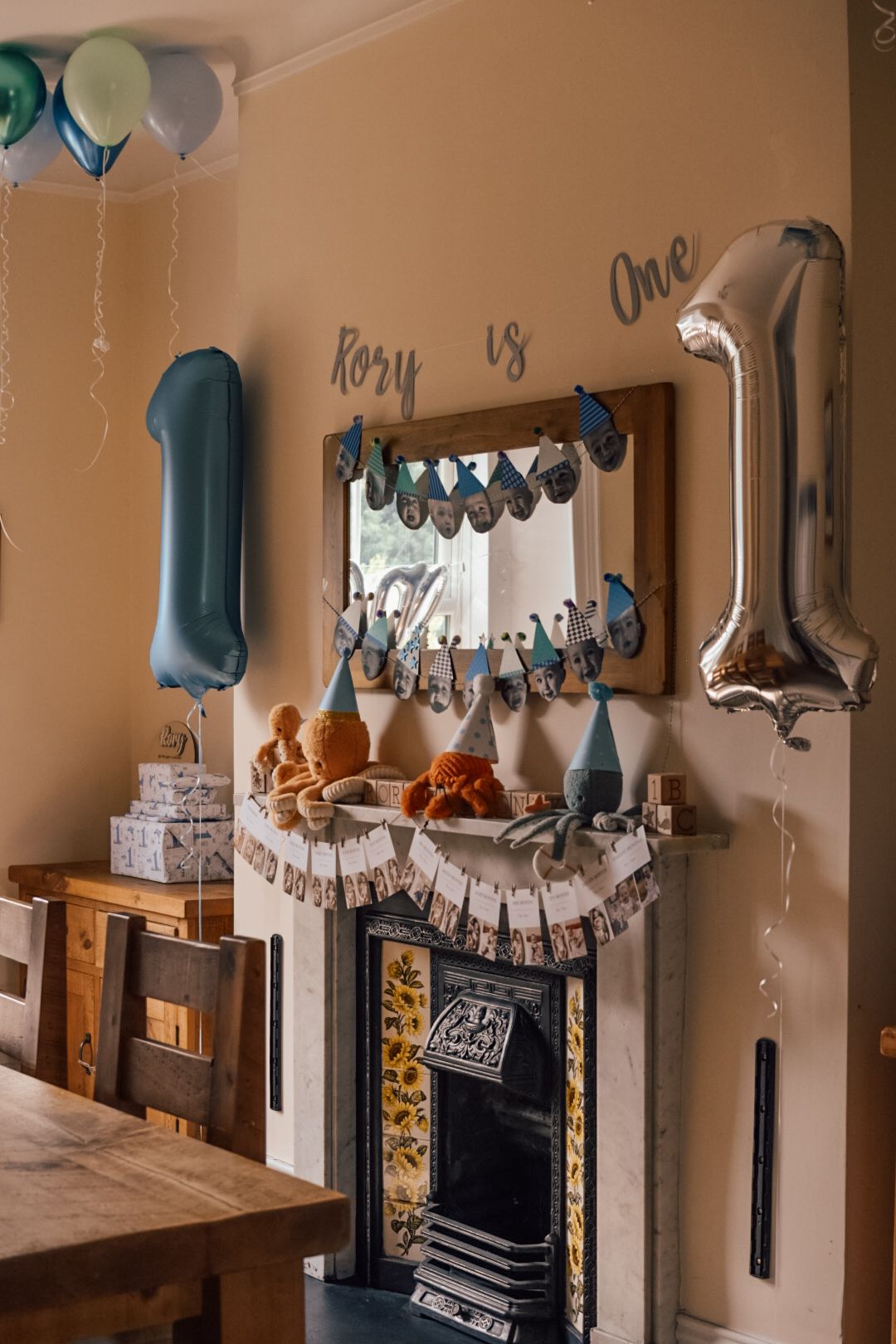 Dining room setup for child's first birthday party with sea theme soft toys and balloons.
