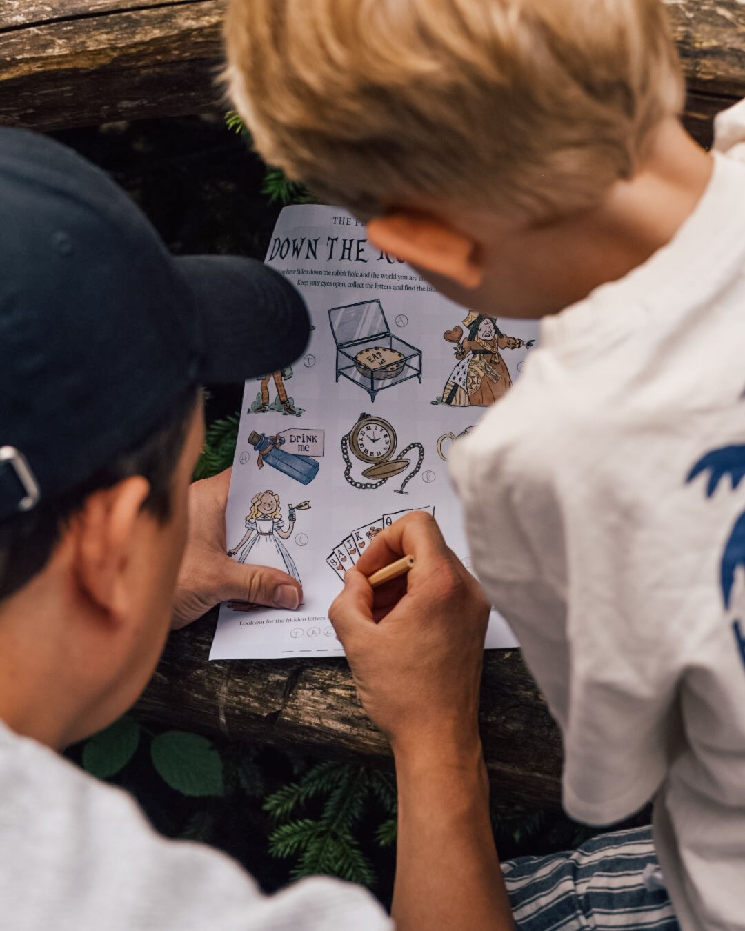 Man filling out activity sheet with boy
