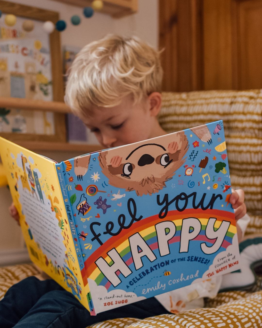 Boy reading Feel your Happy book by Emily Coxhead