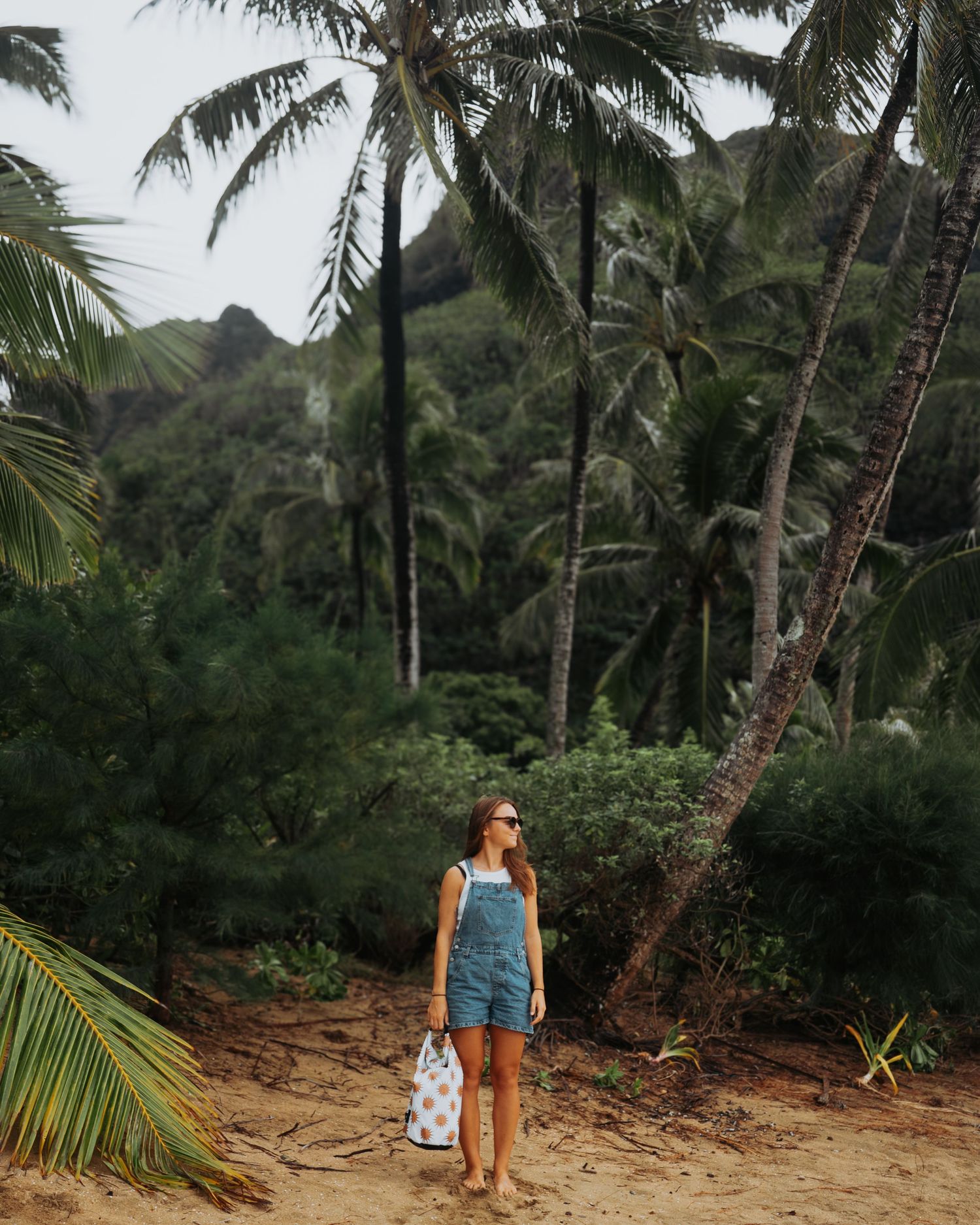 Sunset portrait session at Tunnels Beach on Kaua‘i with golden light, ocean views, palm trees, and tropical beach scenery.