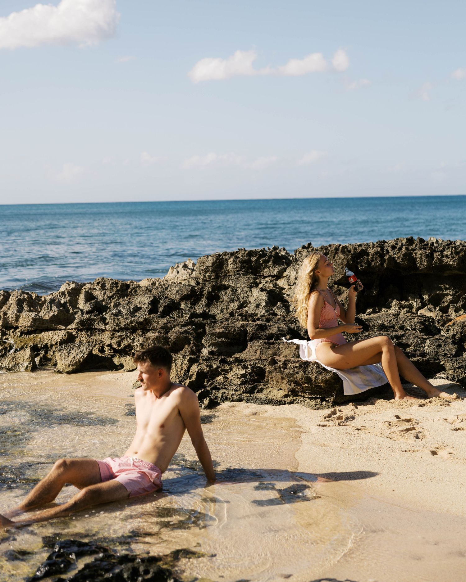 Scenic beach landscape with rocky coastline and crystal blue ocean waters.