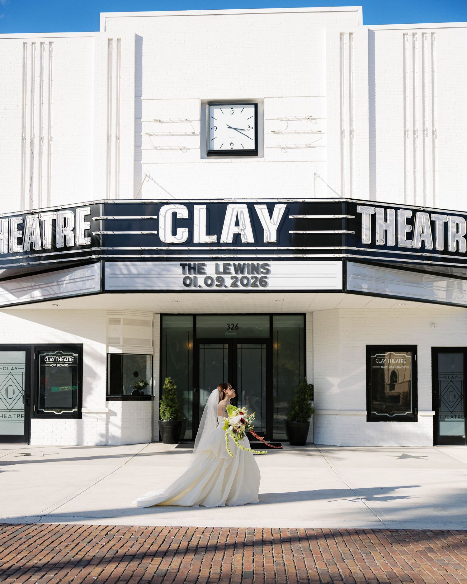 Exterior view of the Clay Theatre with classic white architecture and marquee signage.