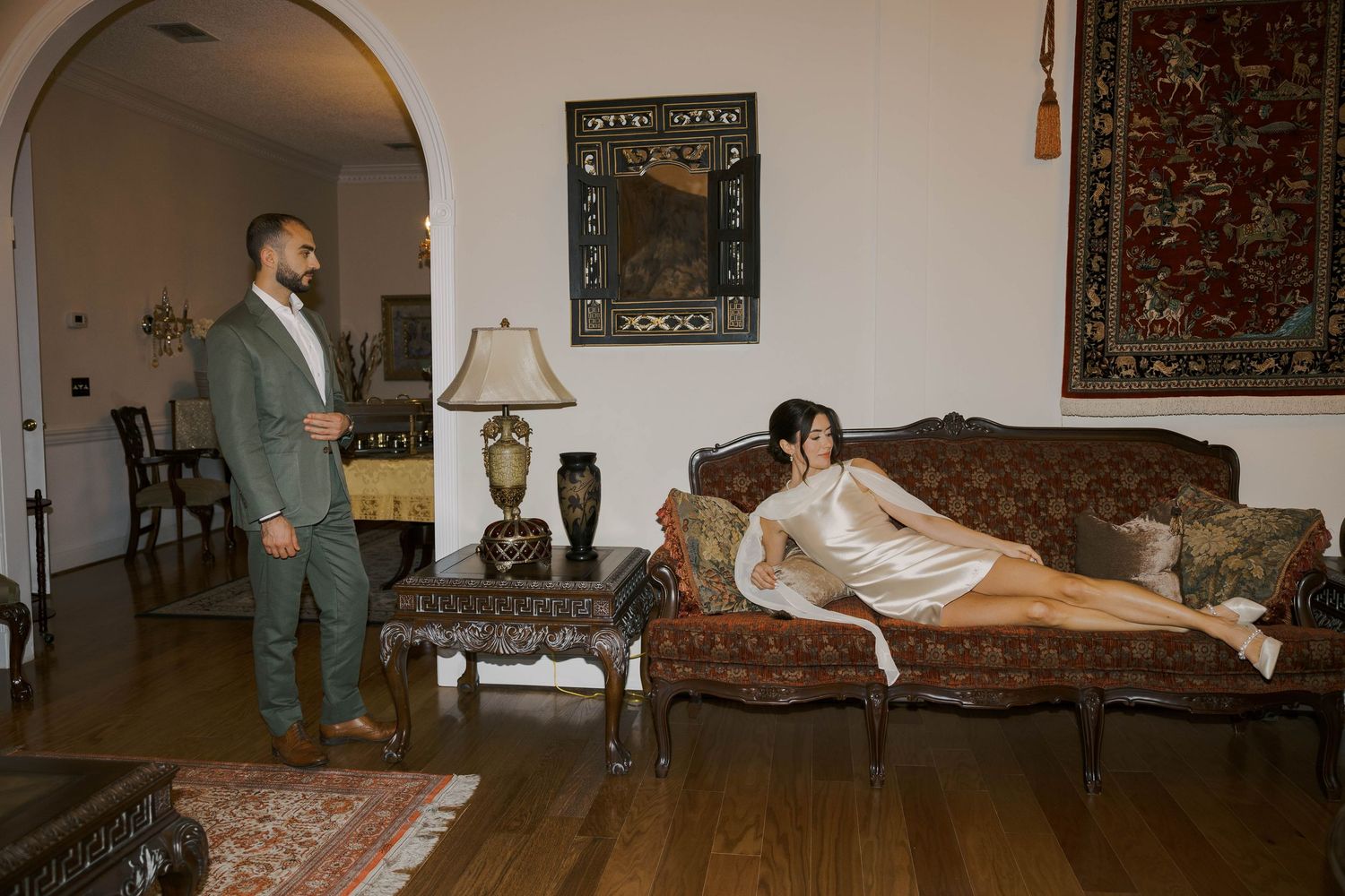 A panoramic view of a living room interior with vintage furniture and decor.