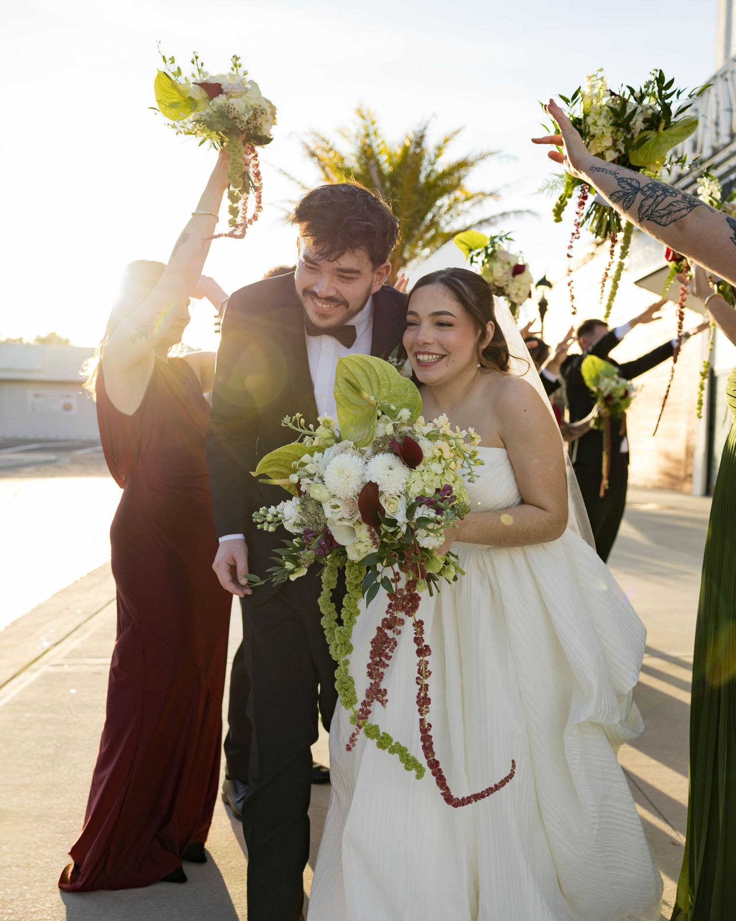 Candid moments of wedding party laughing and celebrating in golden sunset light.