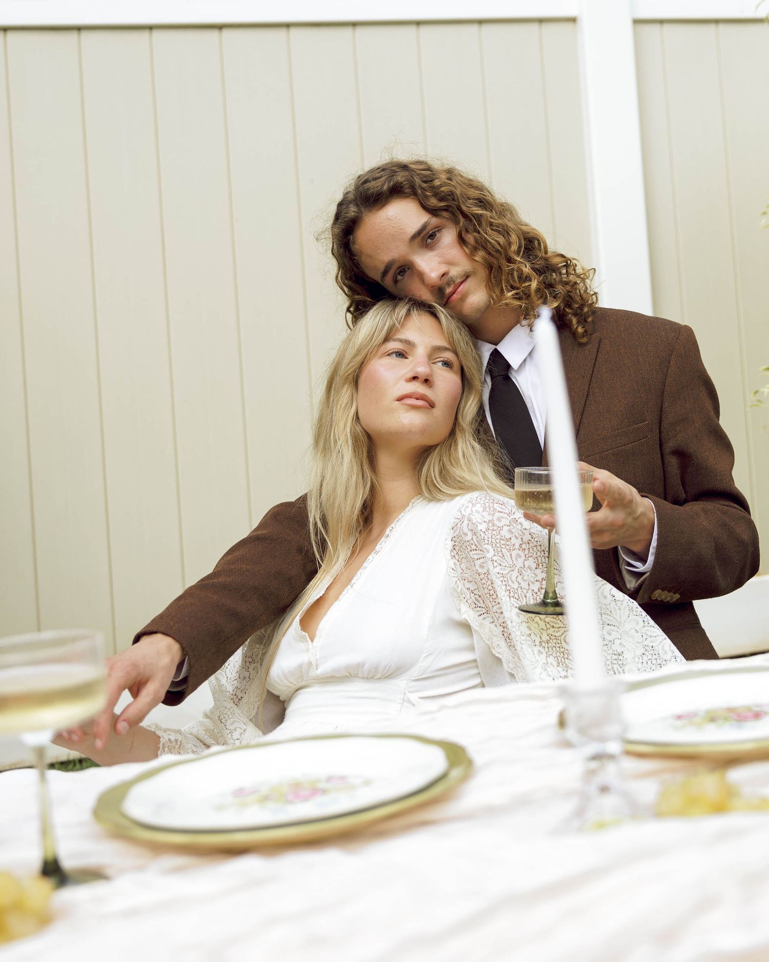 Intimate wedding reception scene with table settings and soft lighting.