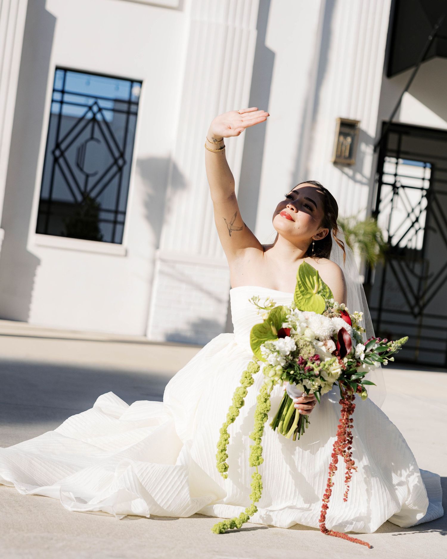 Artistic bridal portraits captured in dramatic poses outside a white columned building.