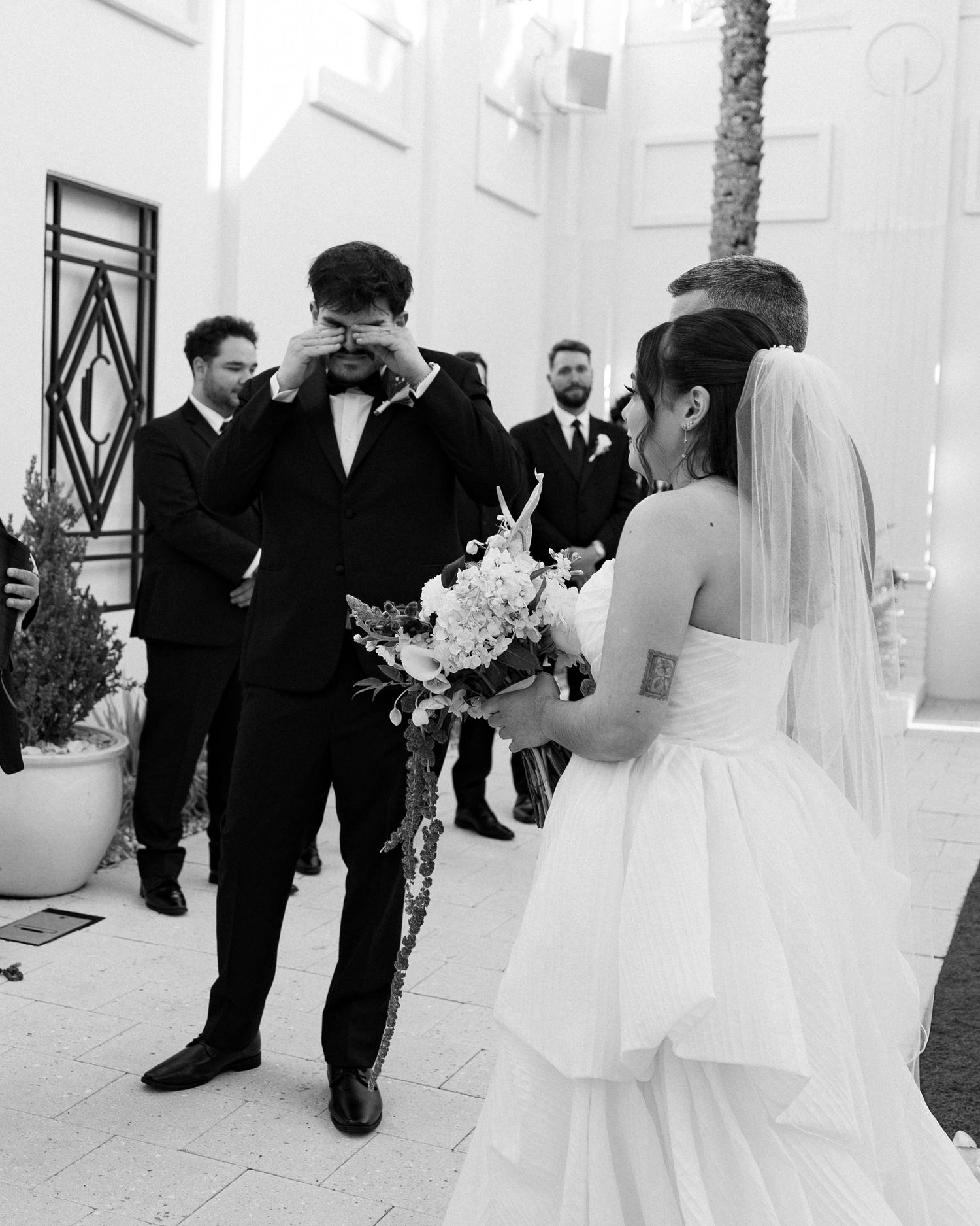 Black and white photo of an emotional wedding moment during the outdoor ceremony.