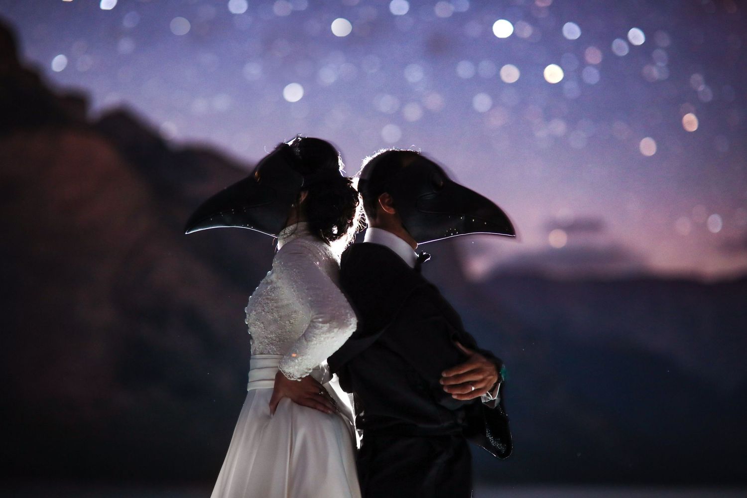 A romantic silhouette of newlyweds embracing against a starry twilight sky during their wedding celebration in Banff National Park Canada