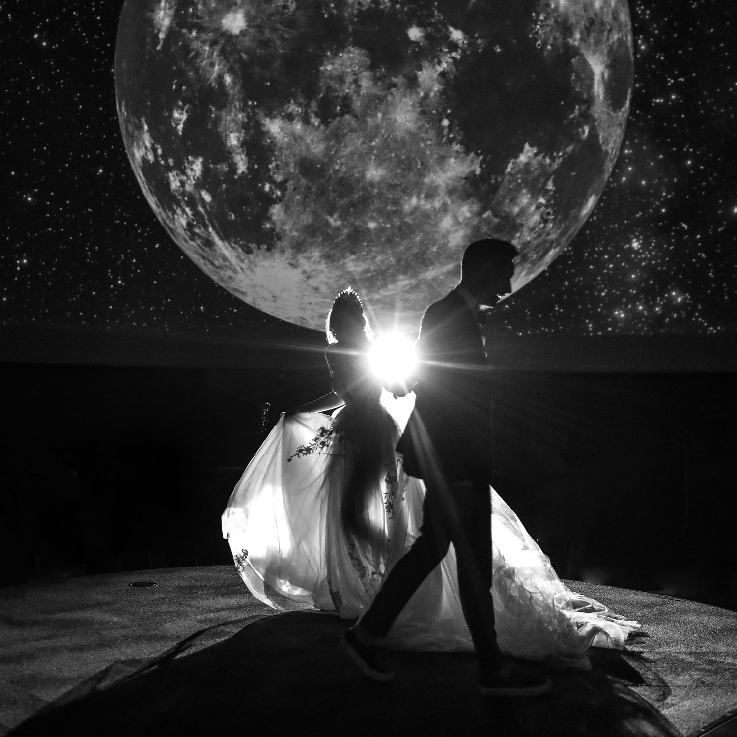 Bride & Groom against a giant full moon backdrop at TELUS World of Science - Edmonton