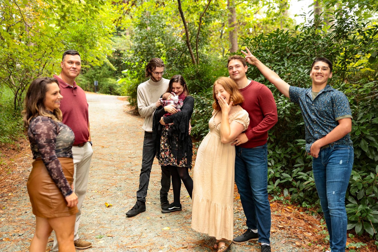 Casual group poses and candid moments captured on a woodland trail during photo session.