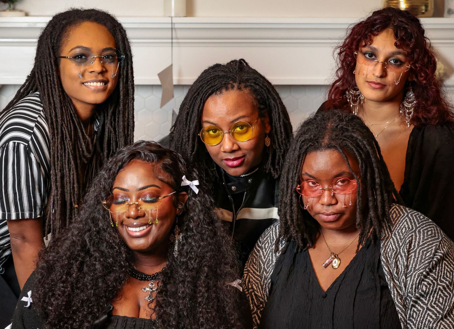 Group photo series showing friends in black and white outfits against neutral background.