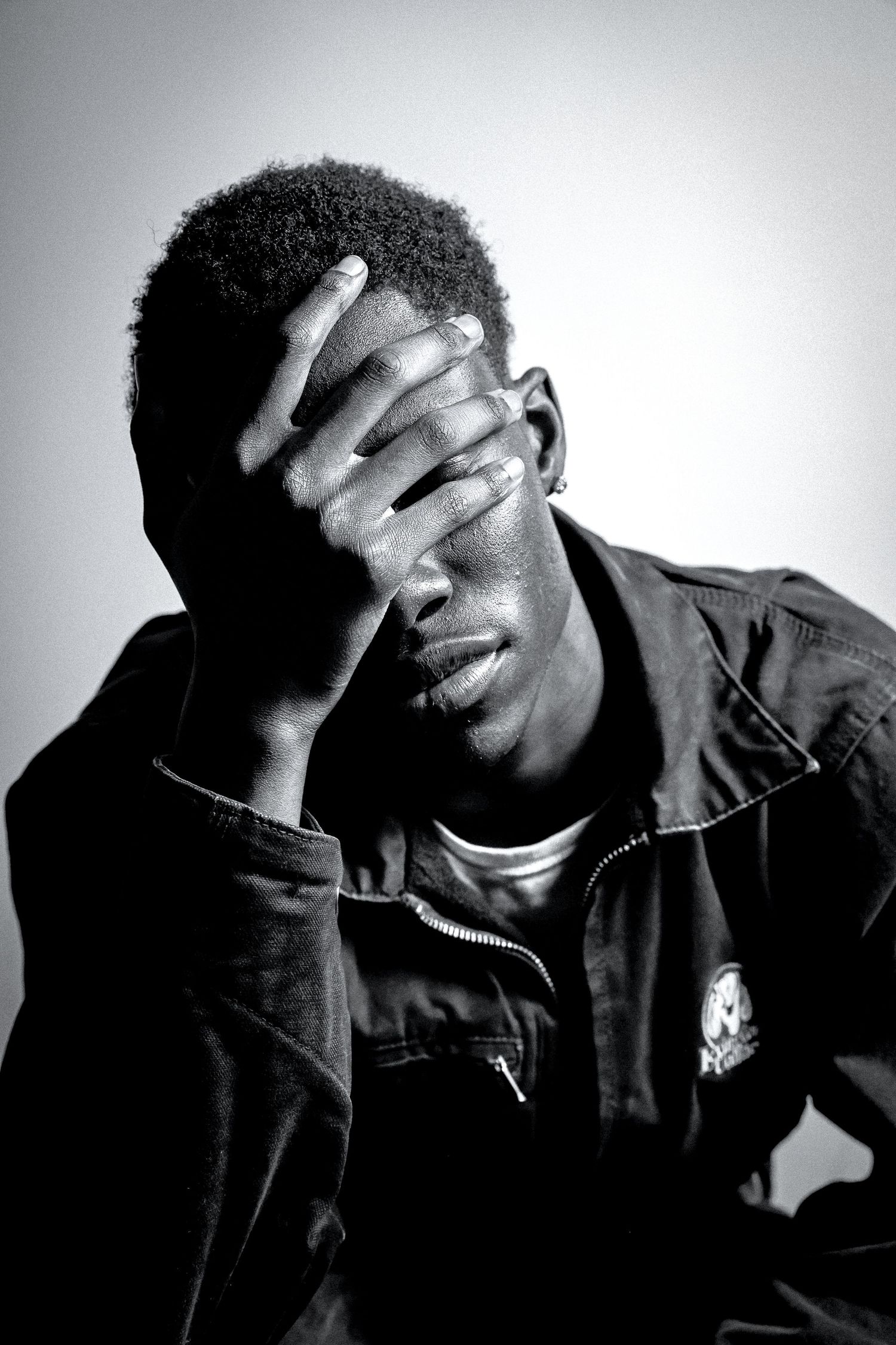 Black and white portraits showing hands covering face in artistic poses.