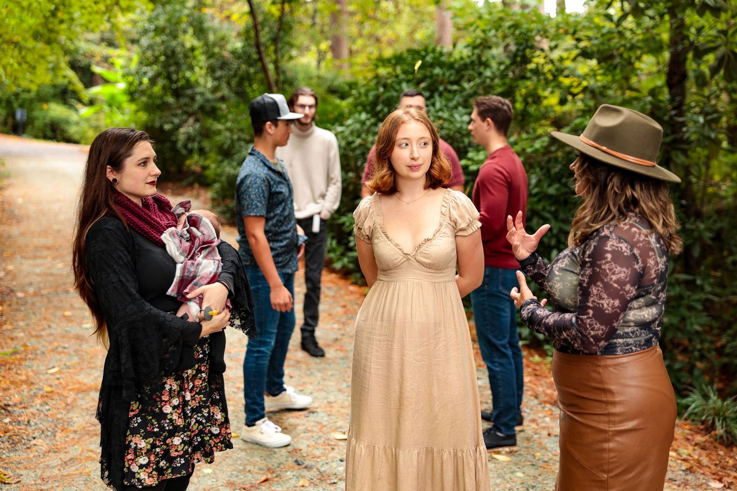 Group photography session with natural interactions on a forest path.