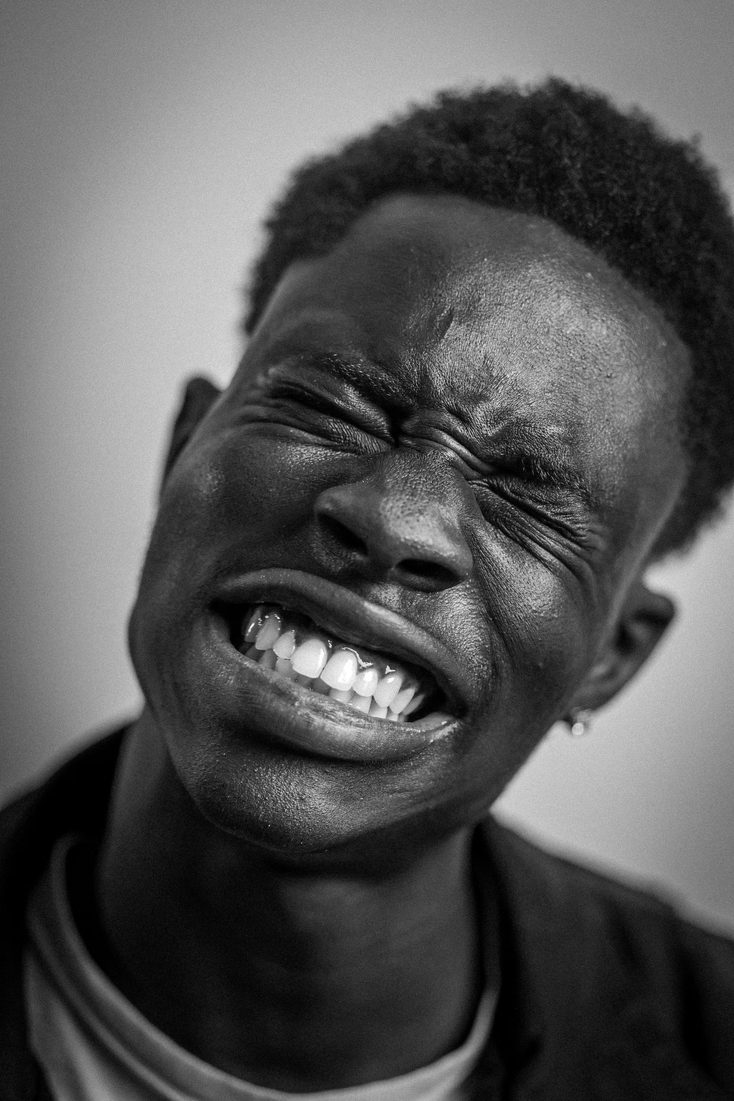 Black and white portraits capturing joyful laughter and genuine smiles.