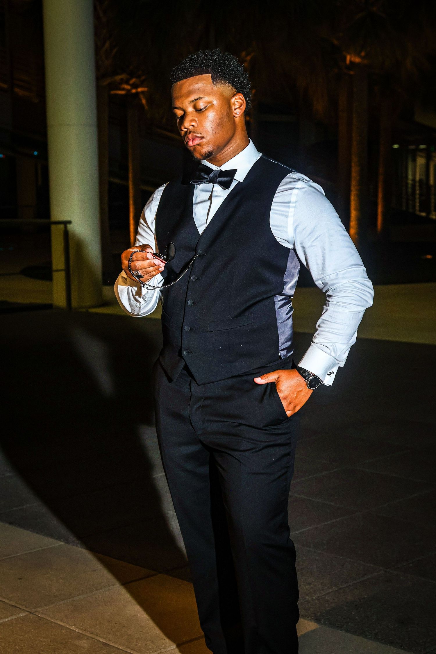 Fashion portraits showing movement in a black vest and white dress shirt combination.