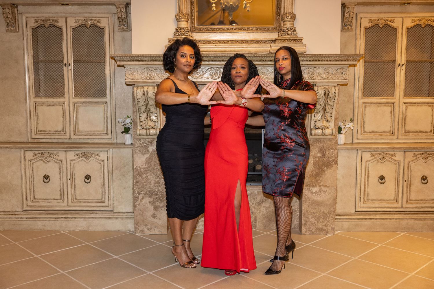 Friends strike playful poses in formal wear against a luxurious interior with gold accents.