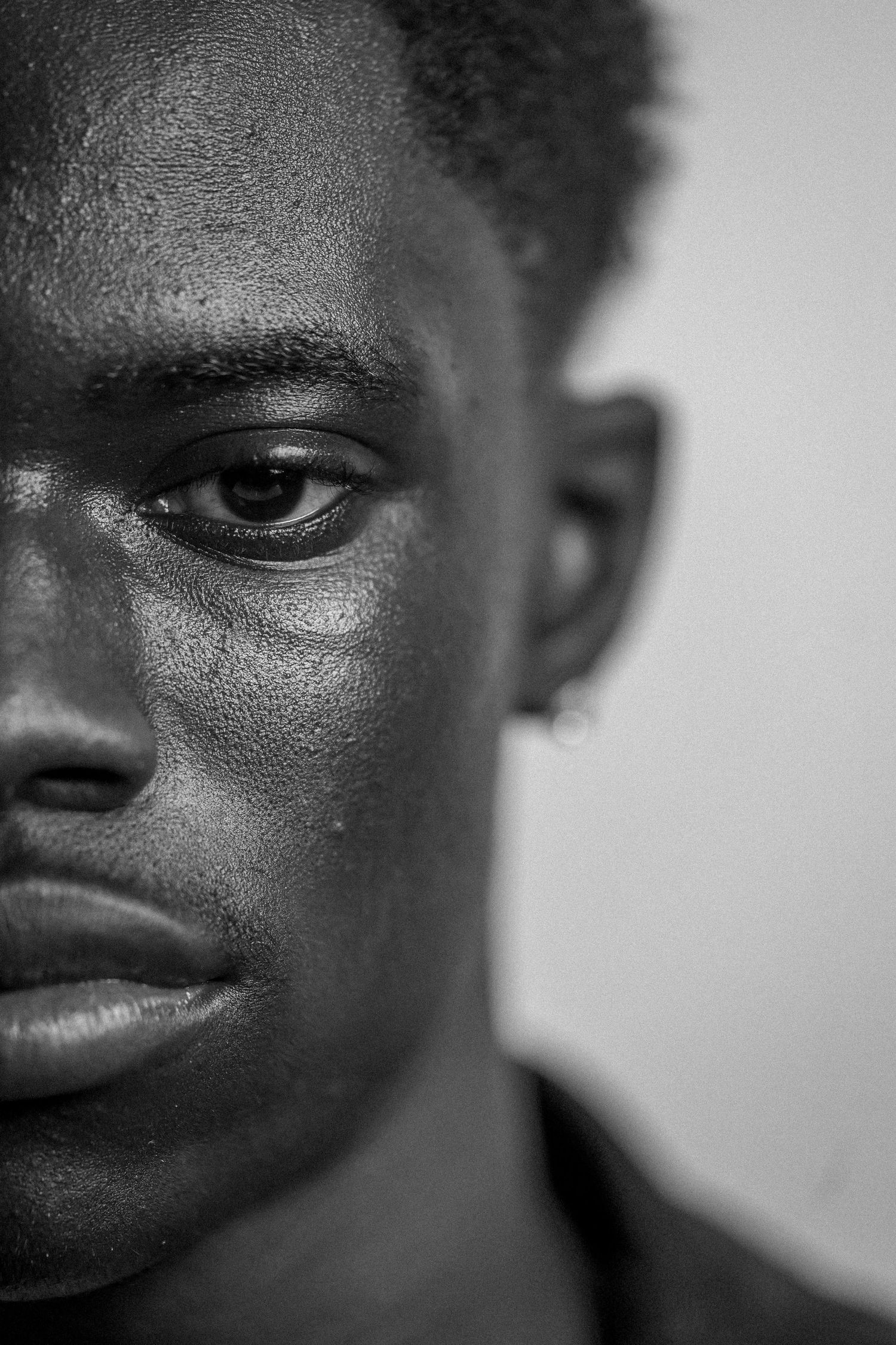 Close-up black and white photographs focusing on facial features and textures.