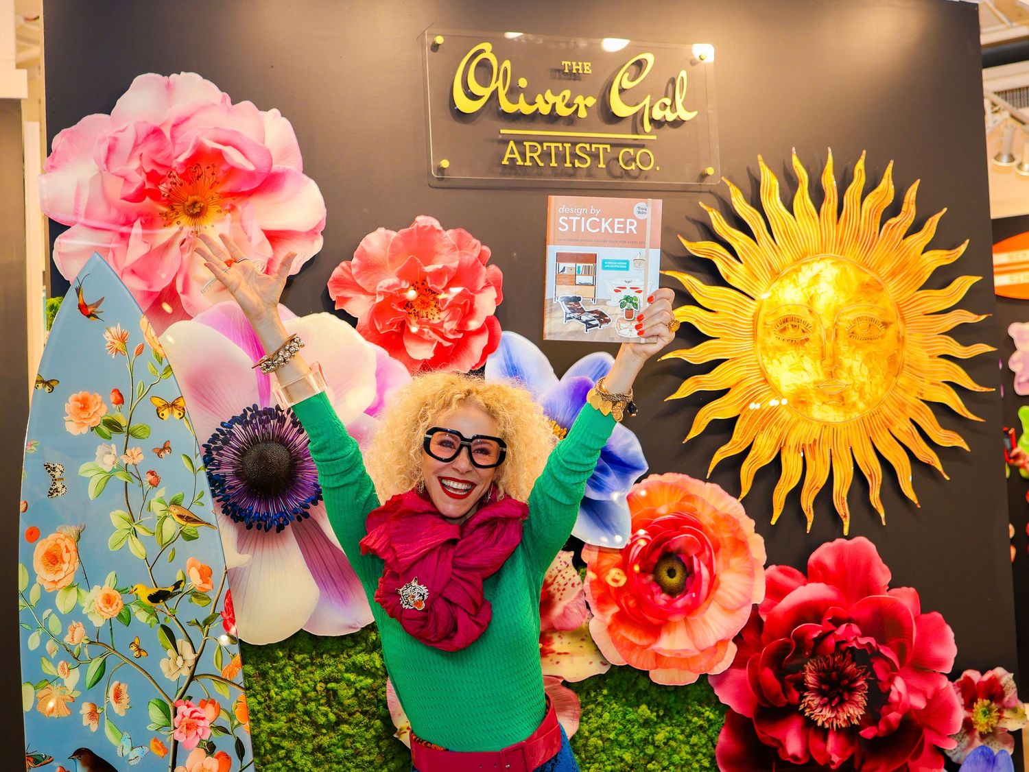 Art gallery wall decorated with paper flowers and a yellow sun design creates a cheerful atmosphere.