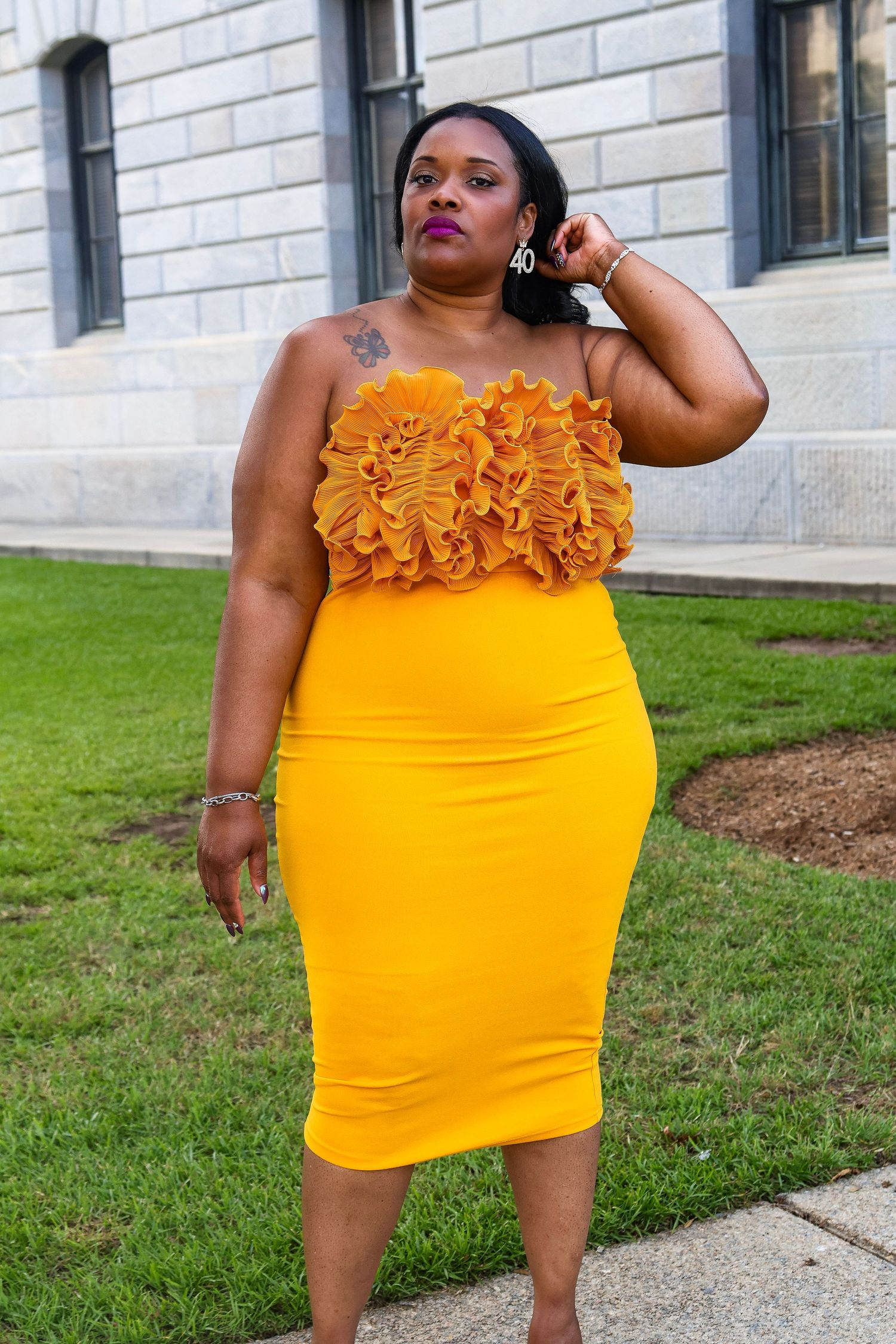 Stylish yellow mini dress with ruffle neckline detail shown in multiple poses.