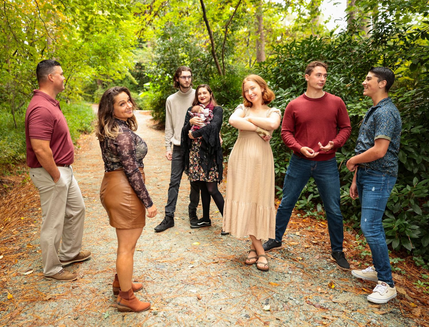 Multiple candid moments captured during an outdoor group photo session on a forest trail.