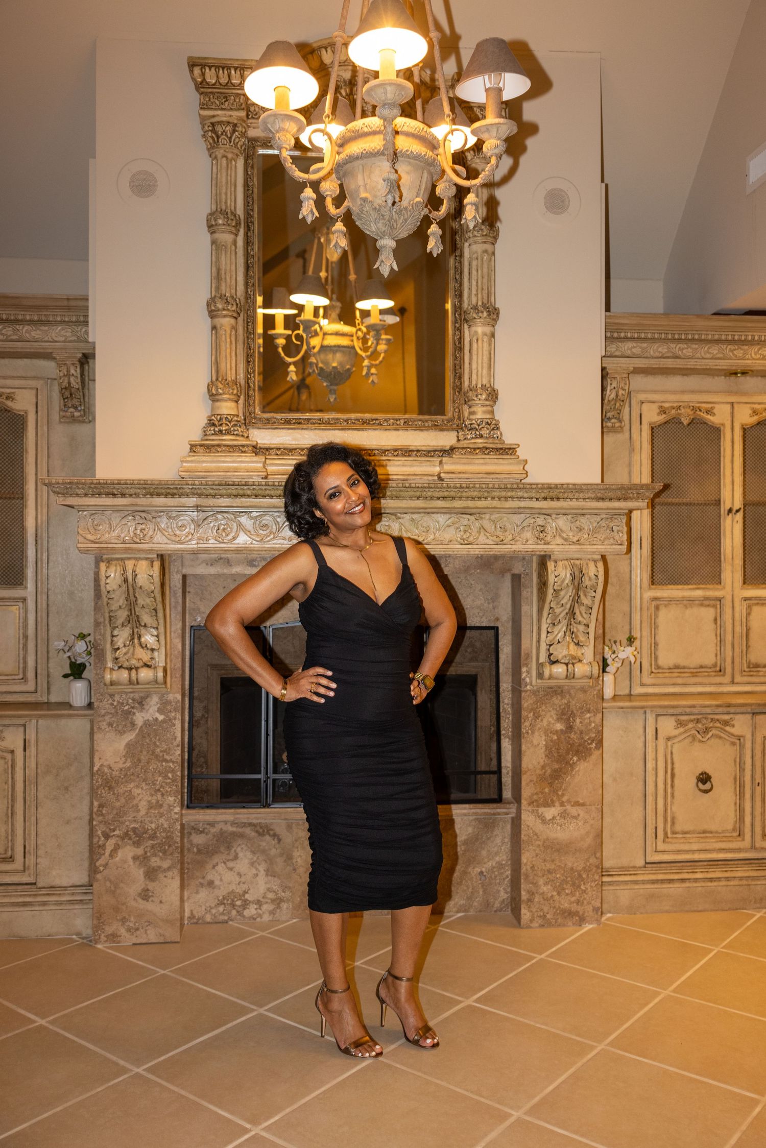 Elegant interior setting with ornate gold mirrors and chandeliers showcasing a formal evening photoshoot.