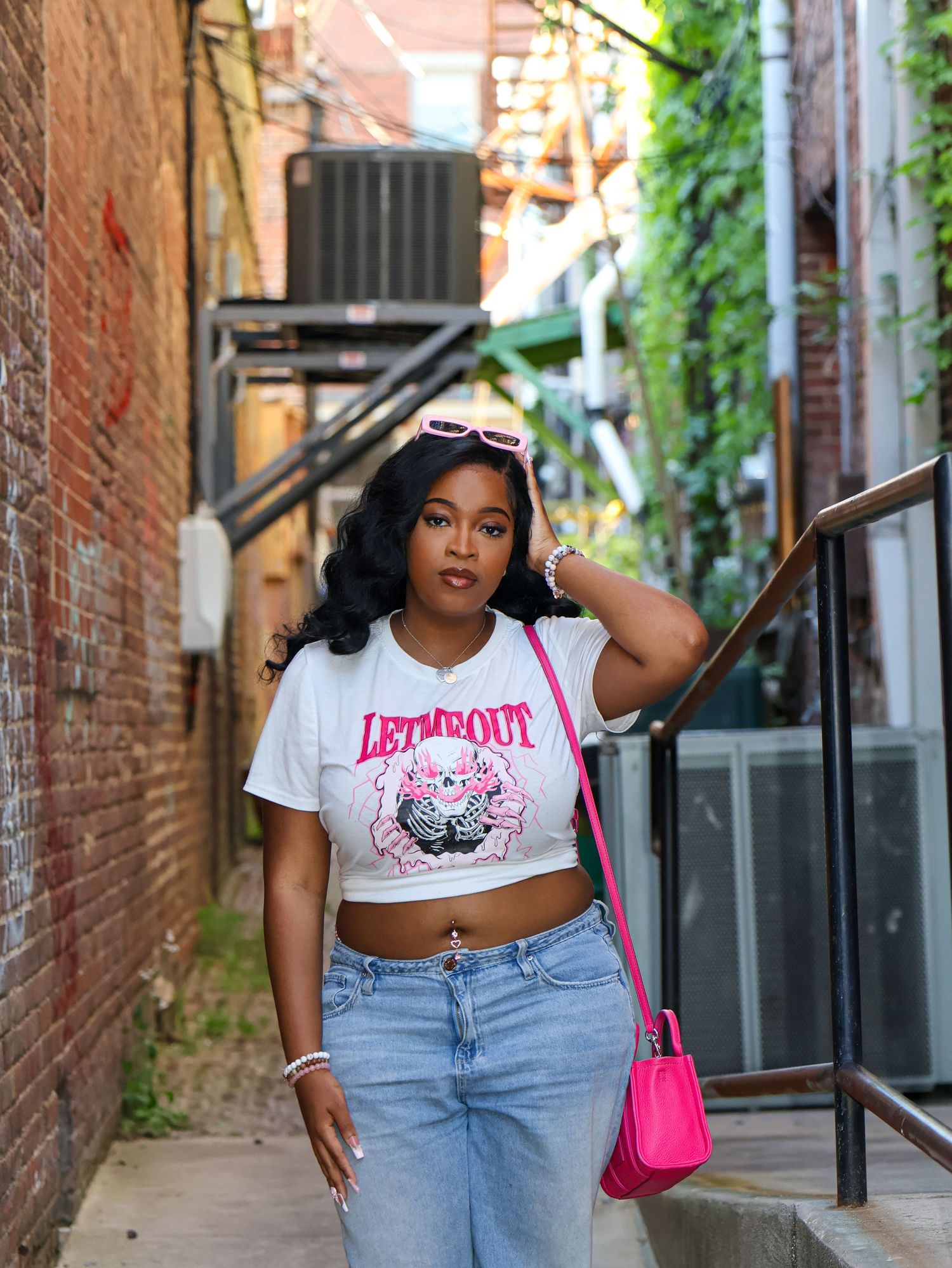 Urban fashion photo in alleyway with brick walls and climbing vines.
