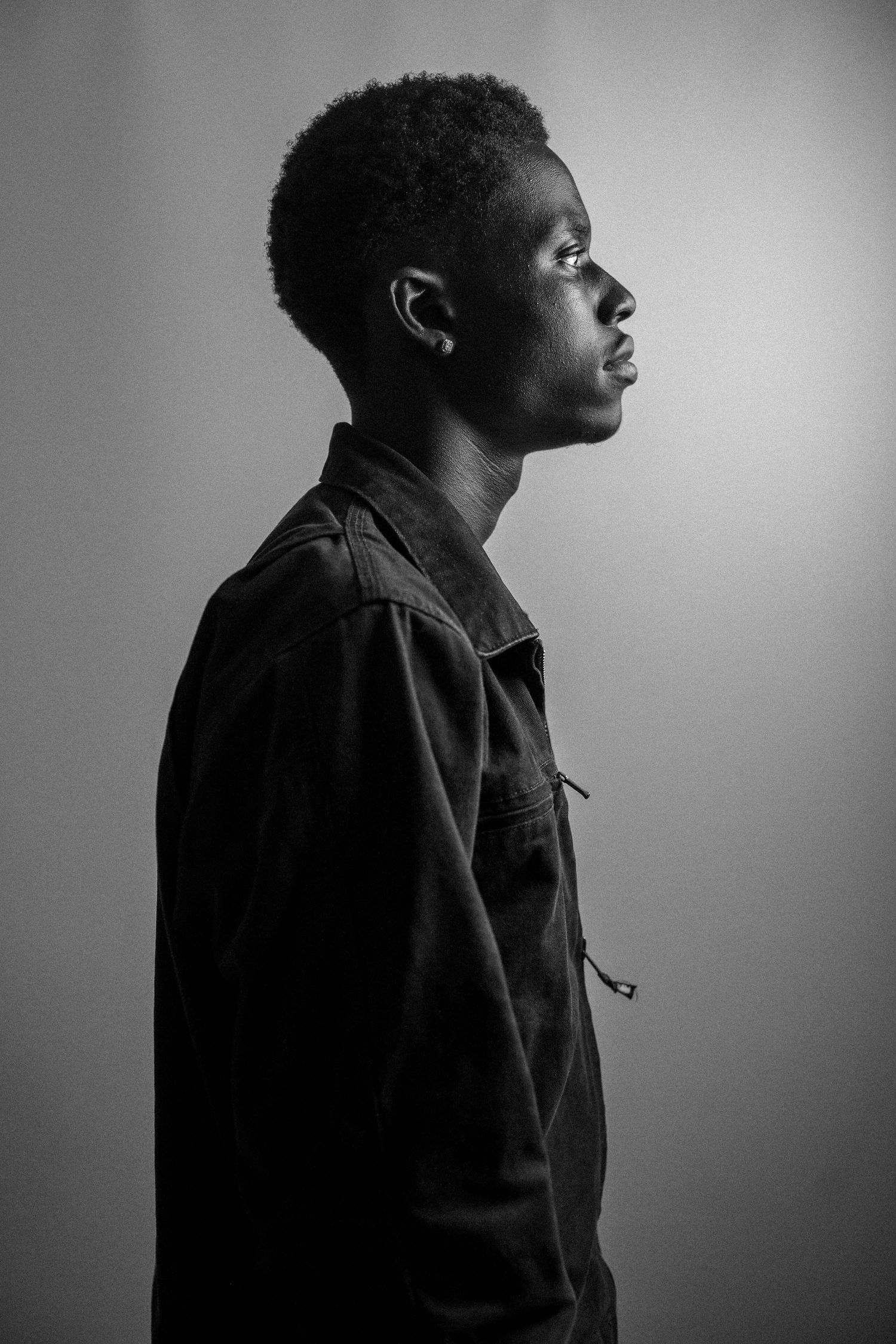 Dramatic side profile portraits in black and white with moody lighting effects.